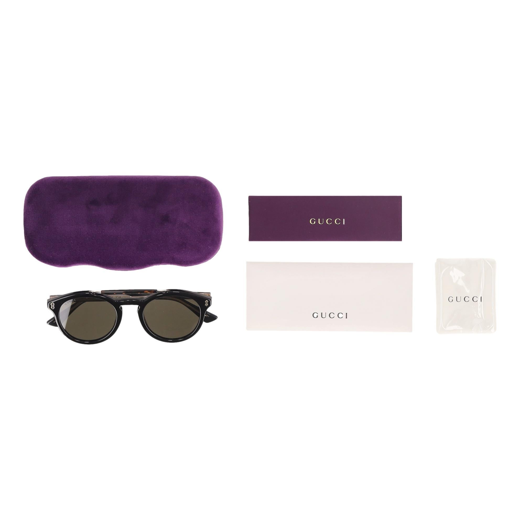 Gafas de sol de aviador con doble puente Gucci

Monturas negras con diseño de doble puente y detalle de habana marrón.

Con lentes grises y detalles metálicos dorados que enmarcan la parte delantera.

Firma 