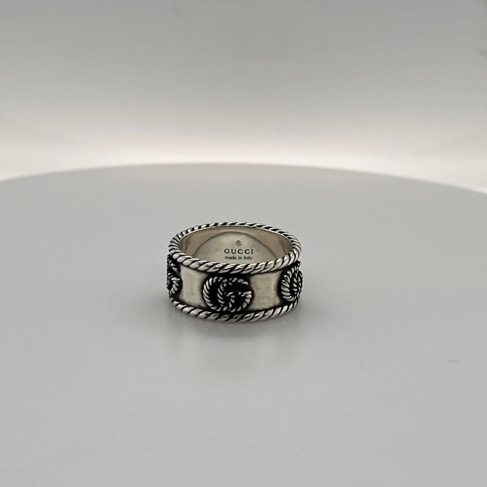 Beautiful GUCCI interlocking double G twisted, torchon design on a thin band ring. Expertly made and intricately designed in 925 sterling silver with an aged finish. Ring size 12, US 6. Band width: 8.8mm. Total weight: 5.82 grams. Made in Italy.