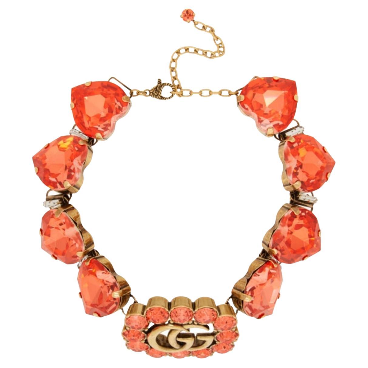 A signature emblem of the House, the initials of its founder Guccio Gucci define this necklace, embellished with heart-shaped crystals. Adding a refined feel, sparkling crystals frame the logo crafted from metal with an aged gold