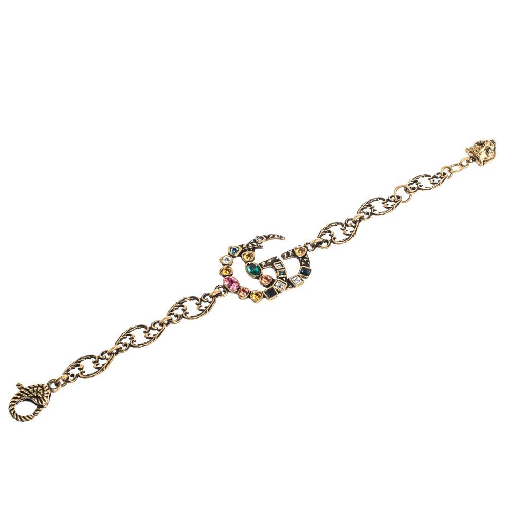 Released as part of the Spring Summer 2018 collection, Gucci smoothly translates the signature Double G motif into this gorgeous bracelet. Designed from gold-tone metal, the bracelet has the GG logo embellished with colourful crystals. A textured