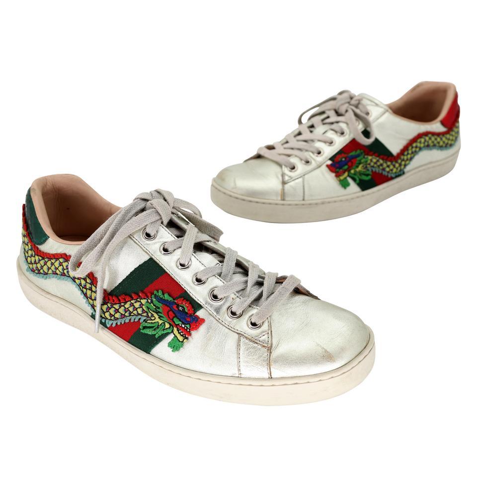 These stylish and extremely rare sneakers are crafted of soft metallic leather and embellished with the iconic Gucci unique Dragon design embroidered at the sides and metallic red and green snakeskin at the heels. These are fabulous eye-catching