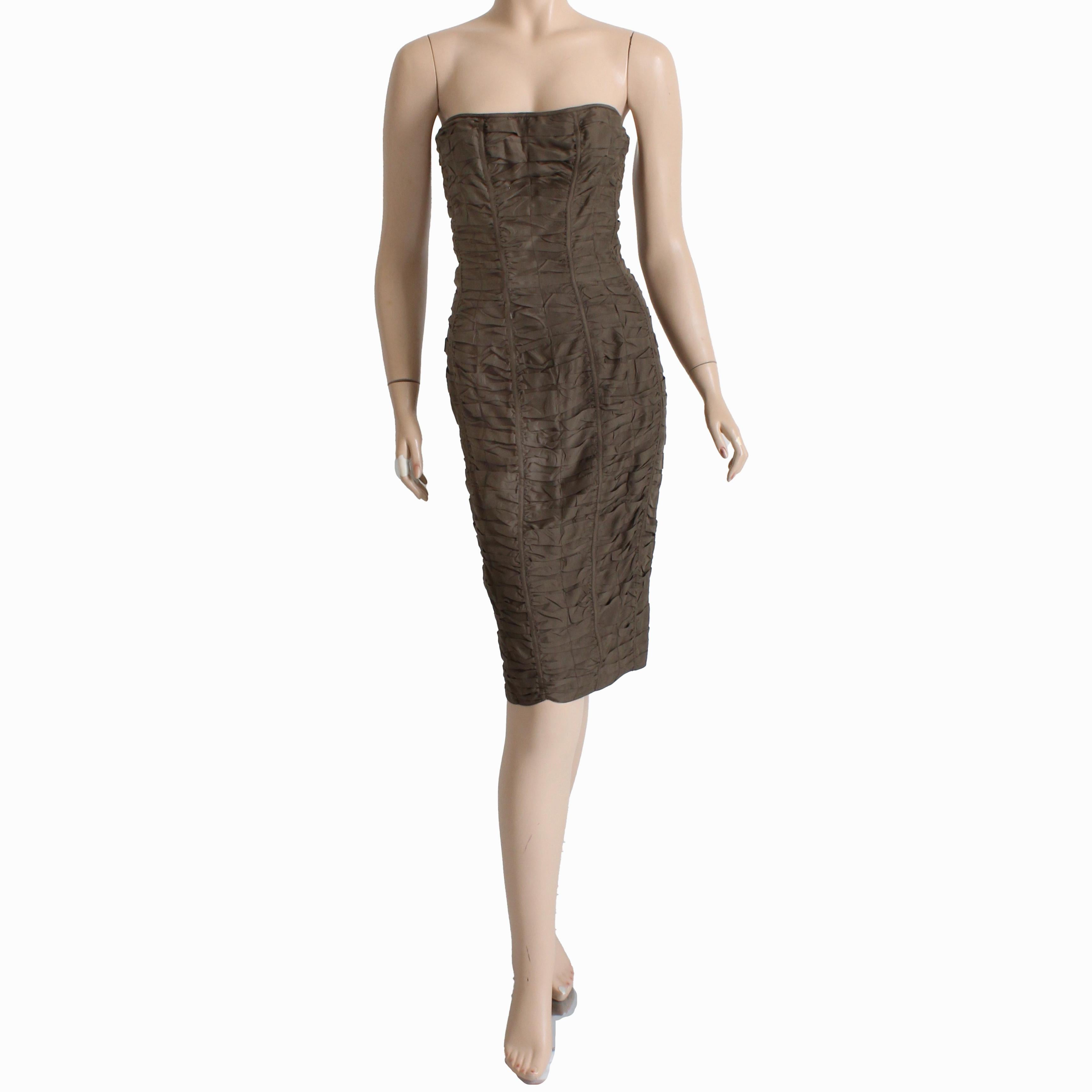 Preowned, vintage and authentic Gucci strapless brown ruched silk dress, from the Spring 2001 collection (Tom Ford era).  Made from an umber-hued brown silk, it features a corset or bustier lined bodice and a sophisticated fitted silhouette with a