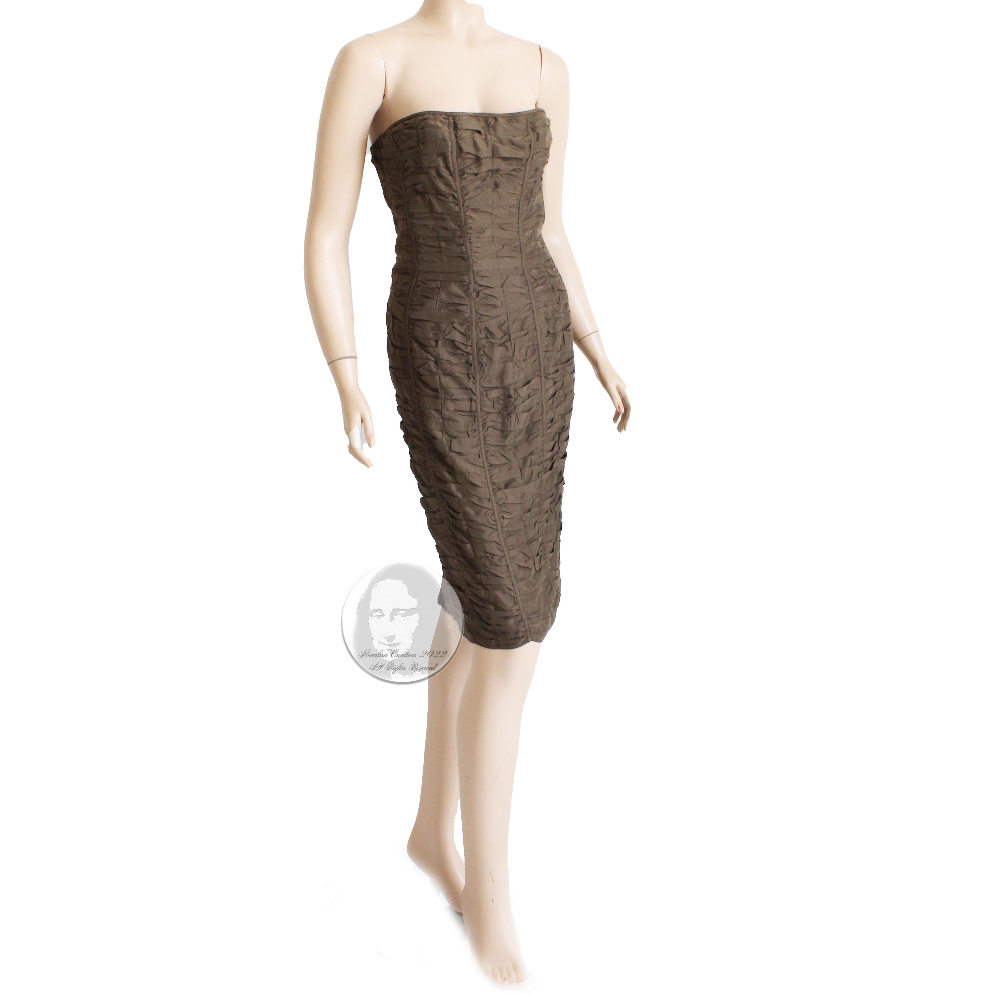 Preowned and authentic Gucci strapless brown ruched silk dress, from the Spring 2001 collection (Tom Ford era).  Made from an umber-hued brown silk, it features a corset or bustier lined bodice and a bodycon silhouette with a chic rear vent. 

A