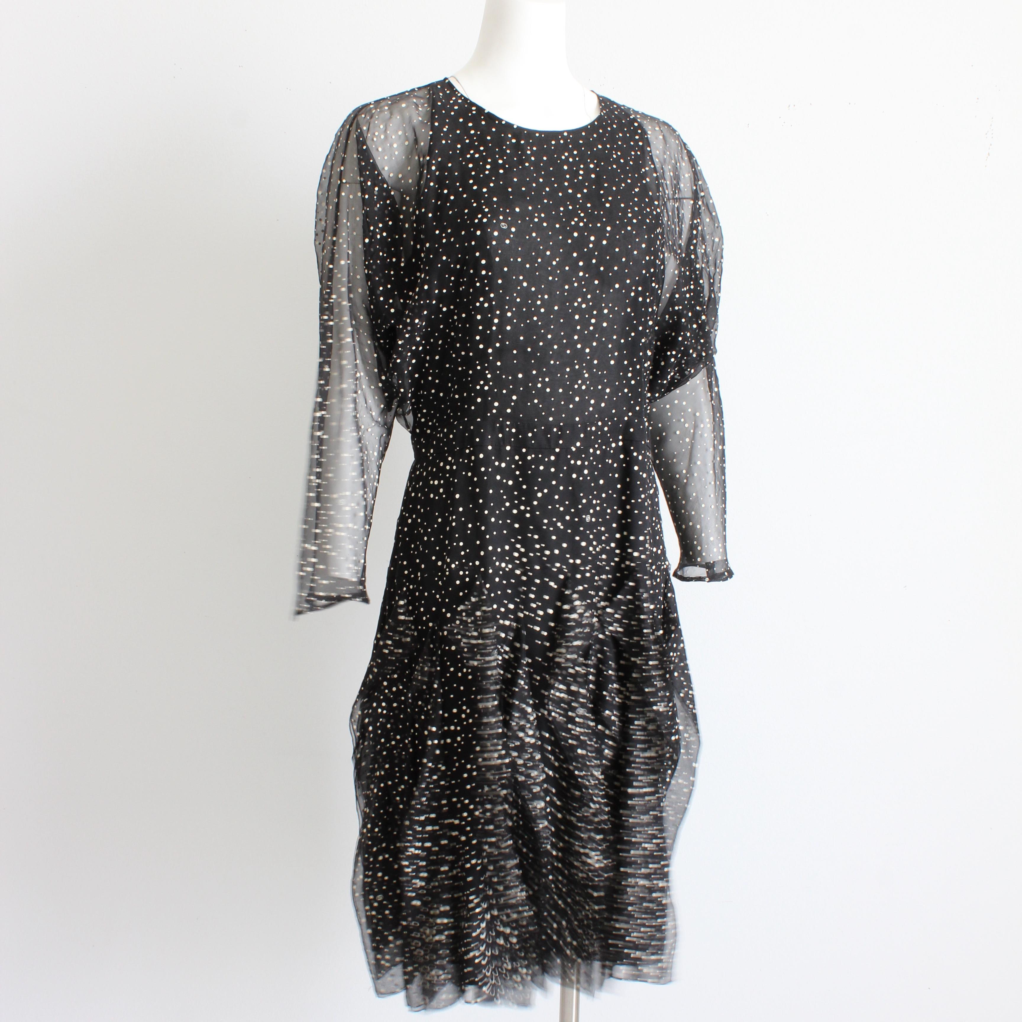 Authentic, preowned Gucci silk polka dot dress with flowing flutter skirt and batwing sleeves, from the F/W 2011 collection (and shown on the runway for Gucci's 90th anniversary celebration). 

Made from black silk chiffon with off white and cream
