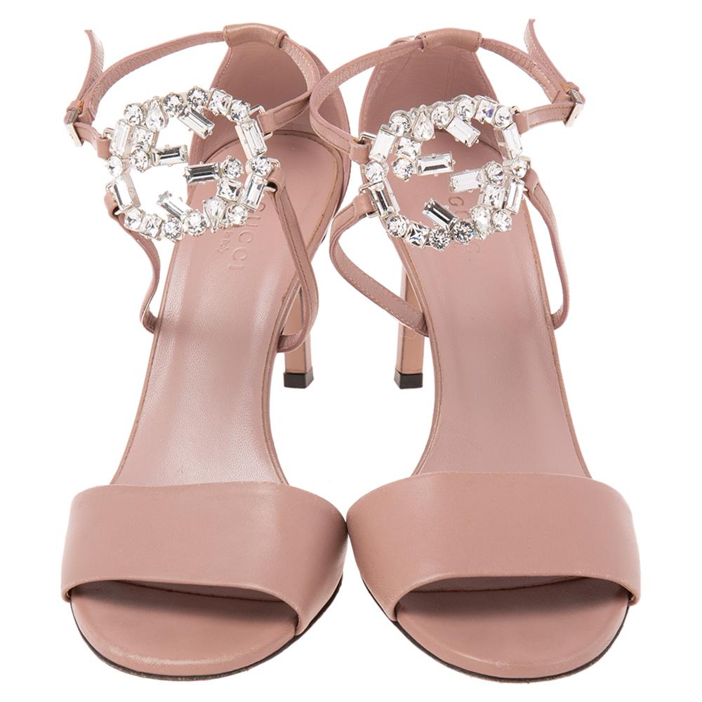 With these sandals from the House of Gucci, your style will look poised and polished! They are made from dusty pink leather, with a crystal-embellished Interlocking G motif perched on the ankle strap. They showcase silver-toned hardware, buckle