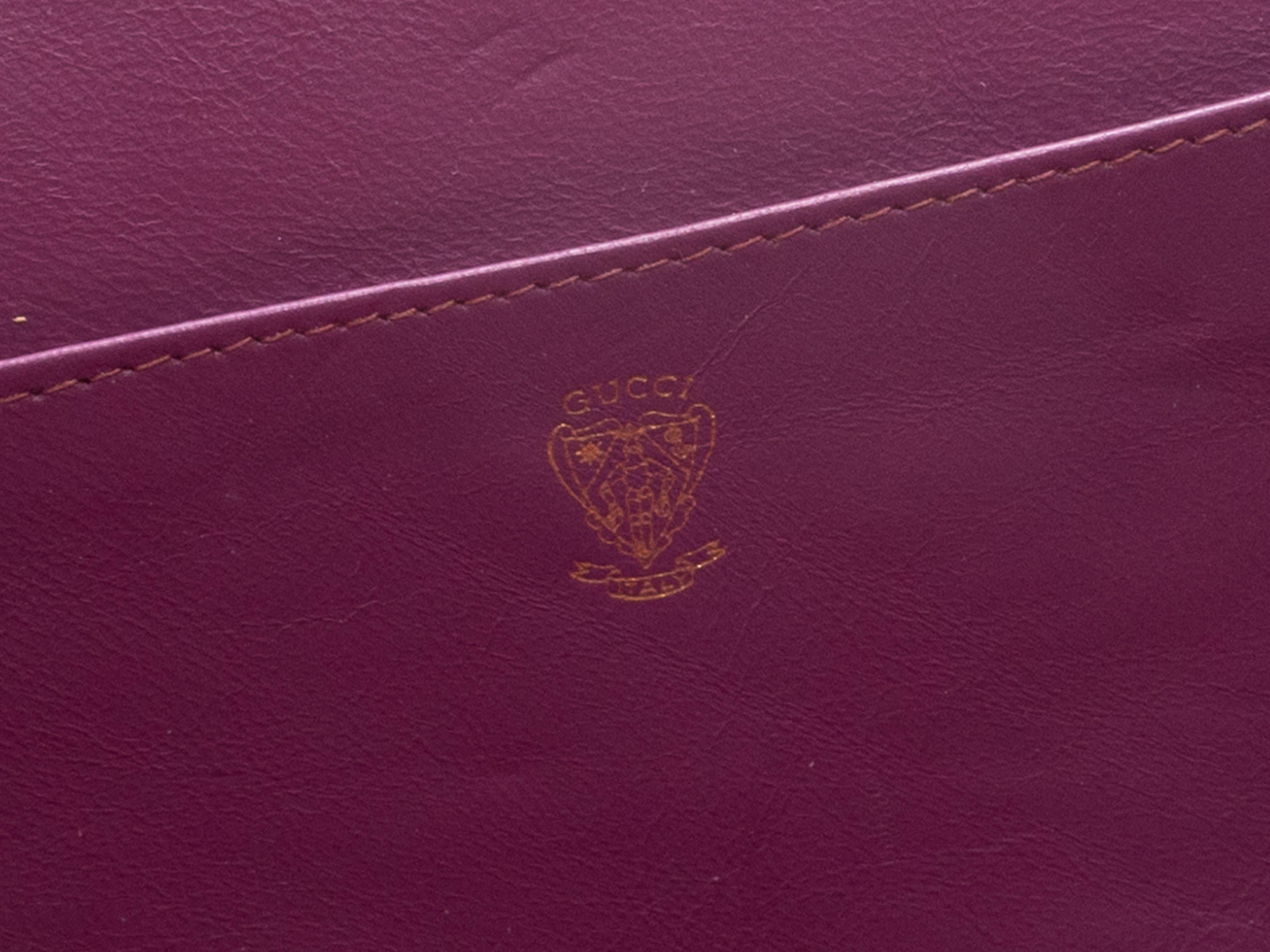 Product Details: Vintage Dusty Rose Gucci Suede Clutch. This clutch features a suede body, gold-tone hardware, a purple leather interior, and a top clasp closure. 8