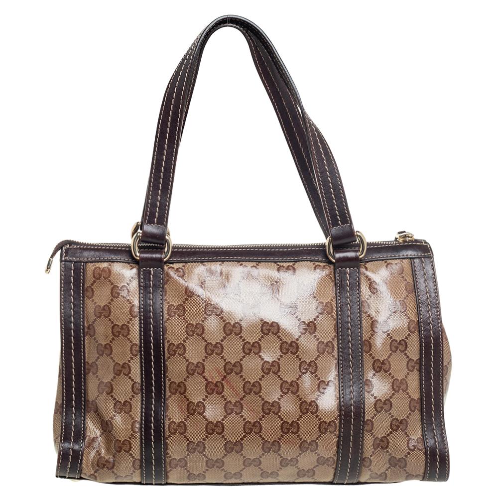 This Duchessa bag by Gucci is crafted from GG crystal canvas as well as leather and styled with a metal bow detail at the front. It features dual leather handles, and the top zip closure opens to a spacious nylon-lined interior to house your