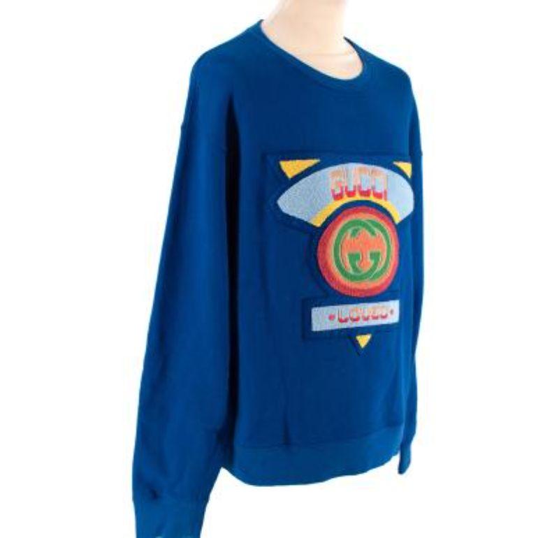 Gucci Electric Blue Cotton Jersey Loved Logo Sweatshirt
 
 - A terrycloth patch in bright colours and shapes decorates the front of this oversize sweatshirt
 - Blue heavy felted cotton jersey
 - Terry cloth Gucci '80s patch with 'Loved Again'
 -