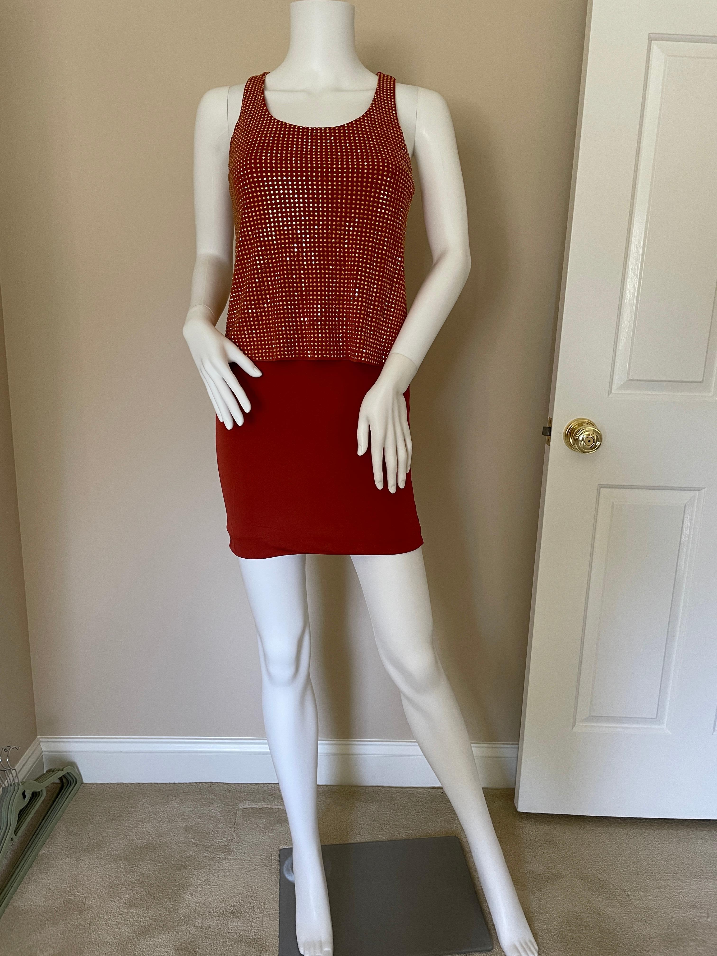 Gucci embellished slinky mini dress! Side zip, size IT 40 with stretch. Shiny sparkle accents of metal type Swarovski crystals. Very flattering, perfect for Summer nights. The color is like a copper, orange, red, and gold blend. It's sleek, sexy,