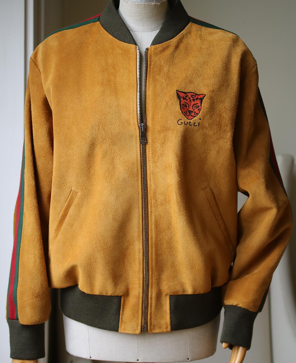 Gucci's suede bomber jacket ticks all the boxes when it comes to new-season outerwear. It's been crafted in Italy from calf suede in a rich mustard shade and is detailed with embroidery at the chest that depicts the label's signature tiger head and