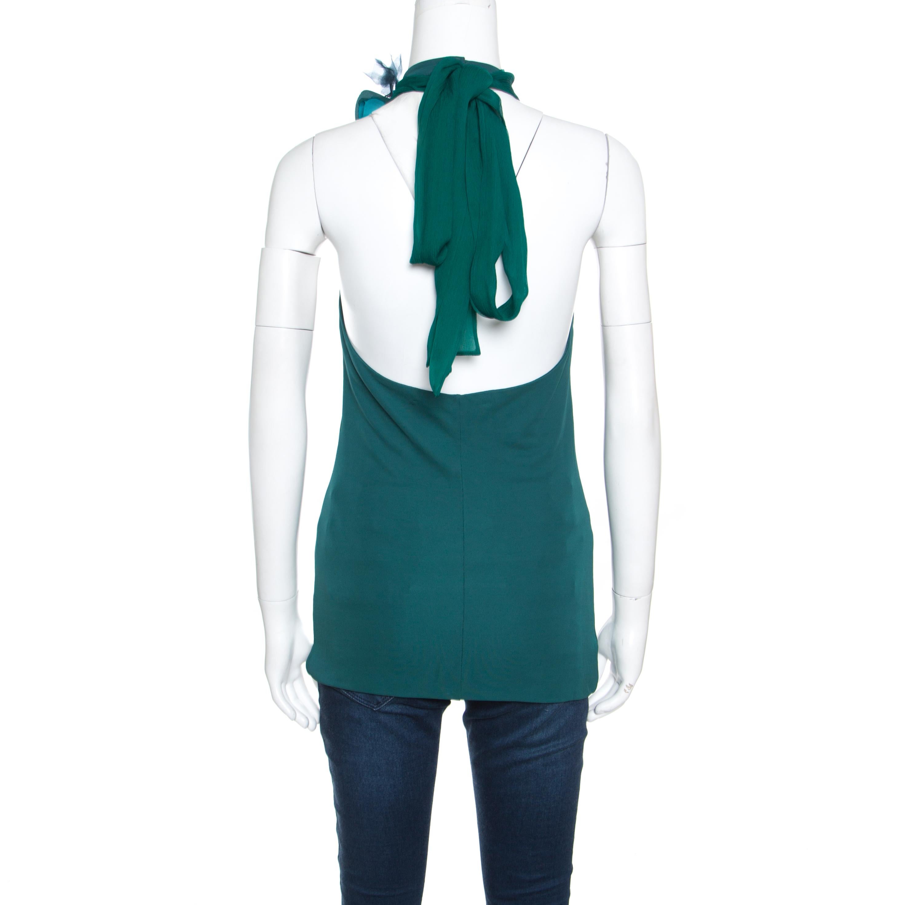 This emerald green top from Gucci is here to make you look fashionably divine. Made from quality fabrics, the top has a halter neckline with an orchid flower applique and a tie at the back. You can wear it with tailored trousers and open toe