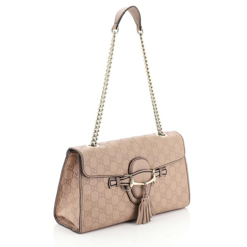 This Gucci Emily Chain Flap Bag Guccissima Leather Medium, crafted in pink embossed guccissima leather, features Gucci's iconic horsebit detail with fringe leather tassels at the front, large chain straps with leather pad, and gold-tone hardware.