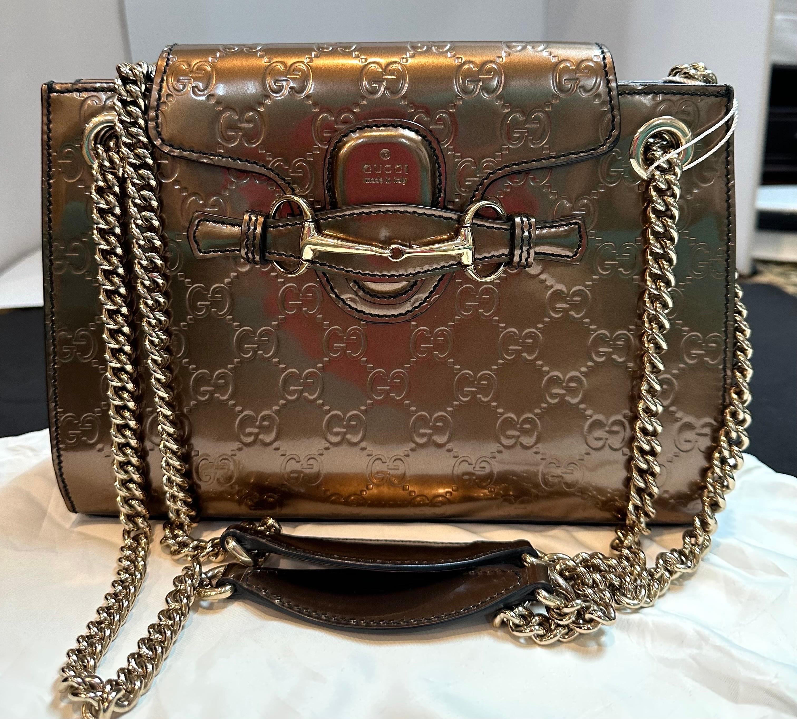 
Bag is in Super excellent condition , just like brand  new 
Bag is brand new , only tassels are missing
Gucci Shoulder Bag
Bronze & Metallic Patent Leather
GG Signature
Gold-Tone Hardware
Double Chain-Link Shoulder Strap

Gucci Emily  GG Bronze