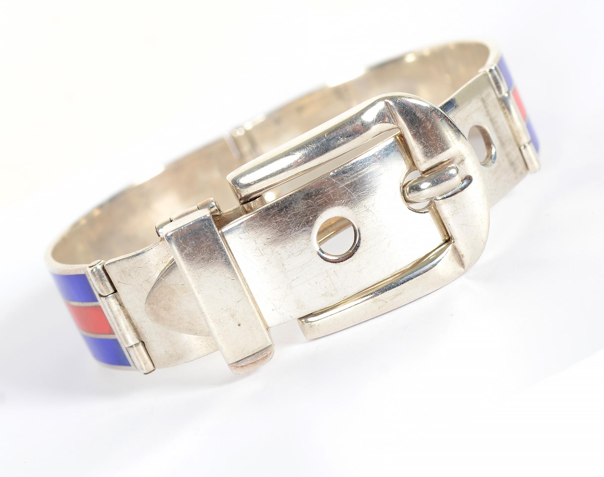 Classic Gucci enamel buckle bracelet on sterling silver done in the perfect colors of red and blue. The bracelet has 3 holes so it can be adjusted to an oval inside diameter of 2 5/16
