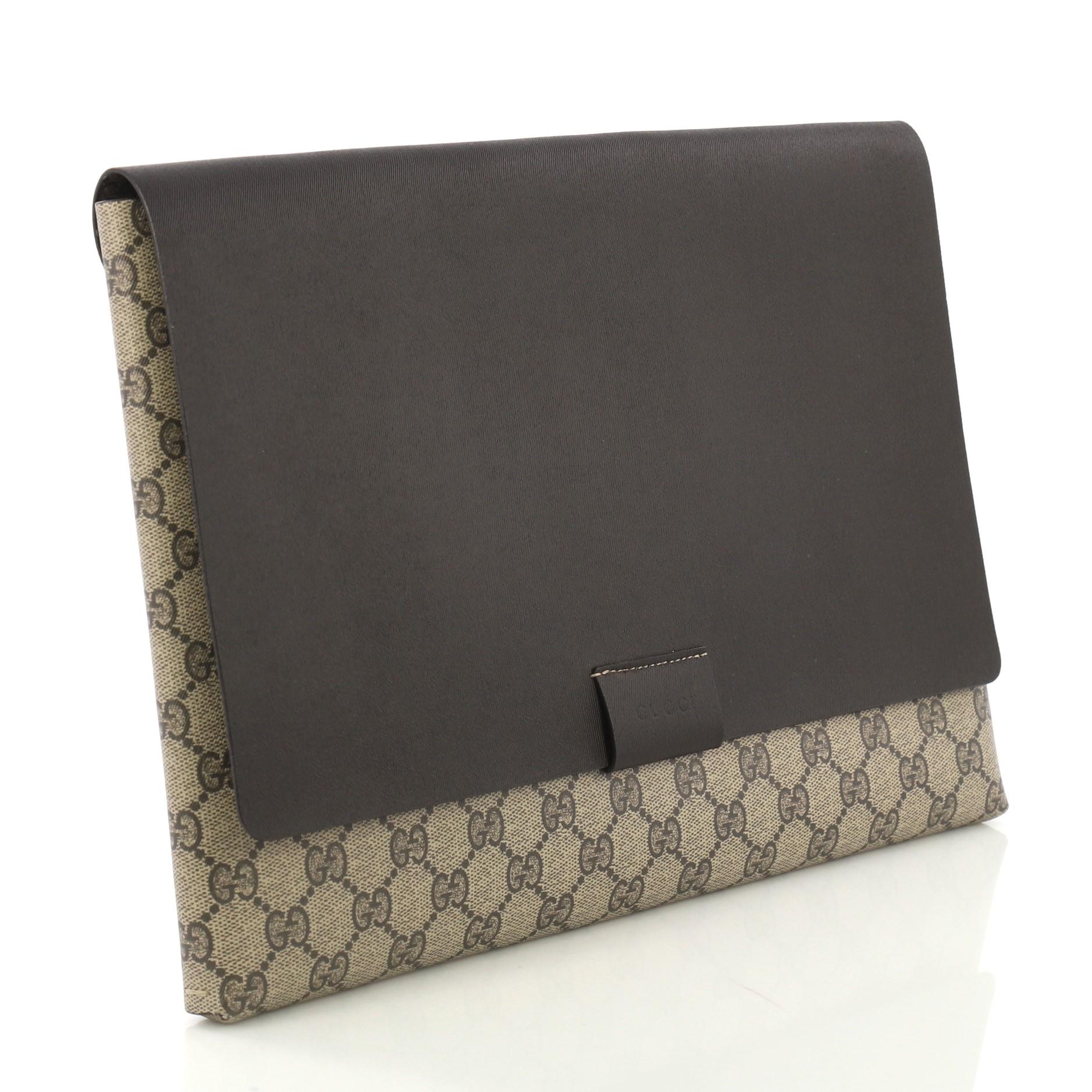 This Gucci Envelope Clutch GG Canvas and Leather Large, crafted from brown GG supreme coated canvas and leather, features stamped logo at the front flap. Its flap opens to a brown leather interior. 

Estimated Retail Price: $900
Condition: