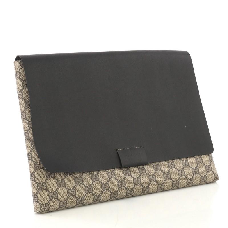 This Gucci Envelope Clutch GG Canvas and Leather Large, crafted from brown GG coated canvas and black leather, features stamped logo at front flap. Its flap opens to a black leather interior. 

Estimated Retail Price: $900
Condition: Damaged.