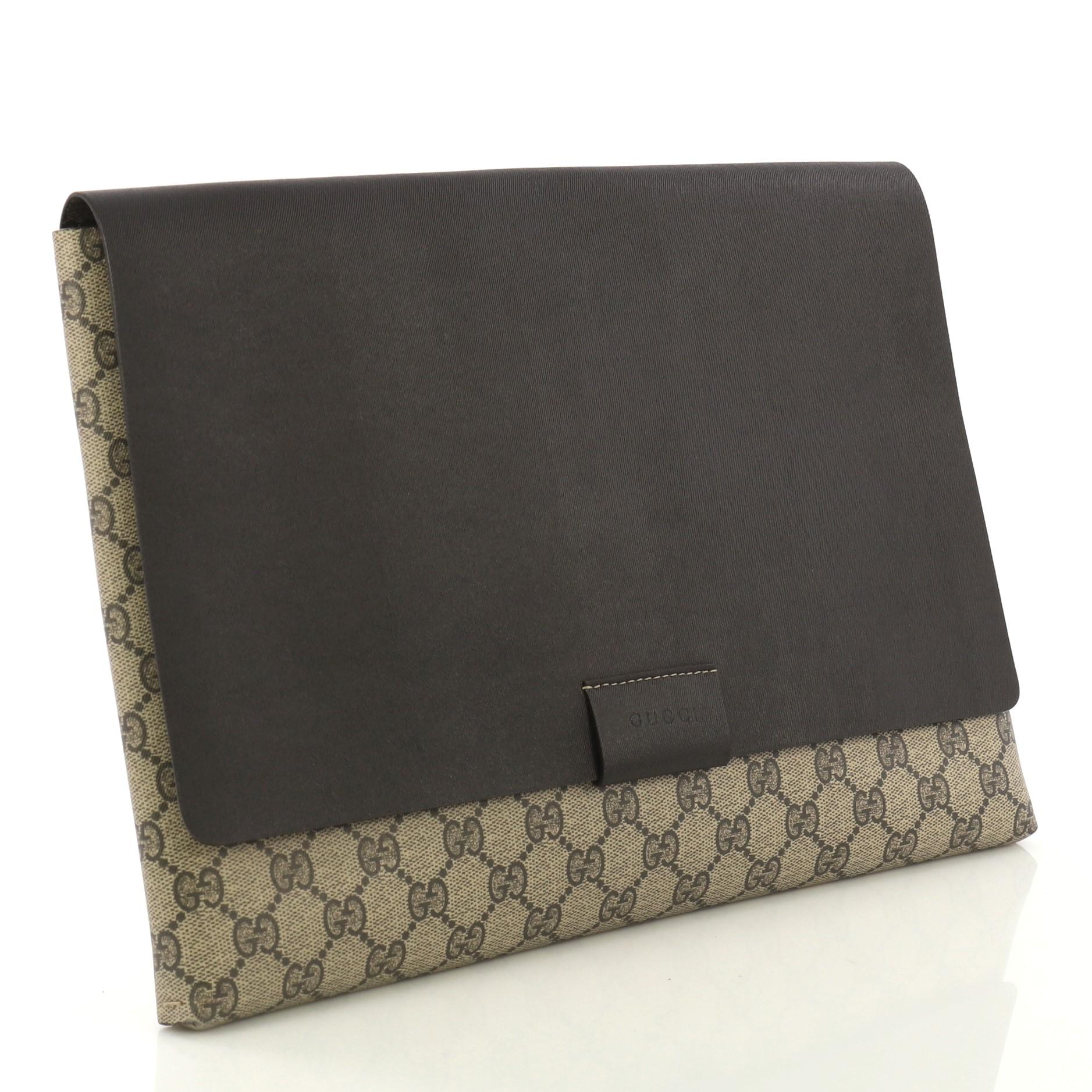 This Gucci Envelope Clutch GG Canvas and Leather Large, crafted from brown GG supreme coated canvas and leather, features stamped logo at the front flap. Its flap opens to a brown leather interior.

Estimated Retail Price: $900
Condition: Excellent.
