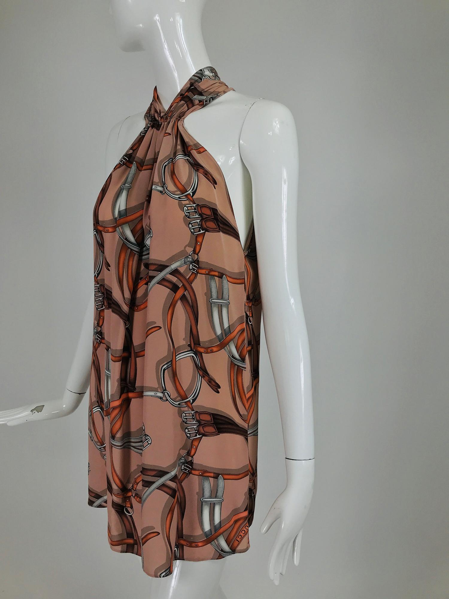 Gucci Equestrian label stirrup and harness print silk halter tunic marked size 48.  Shirred neckline, sleeveless tunic/top with deep arm openings. Closes at the back with a zipper and hook and eye.  Looks barely, if ever, worn. Fits like a large but