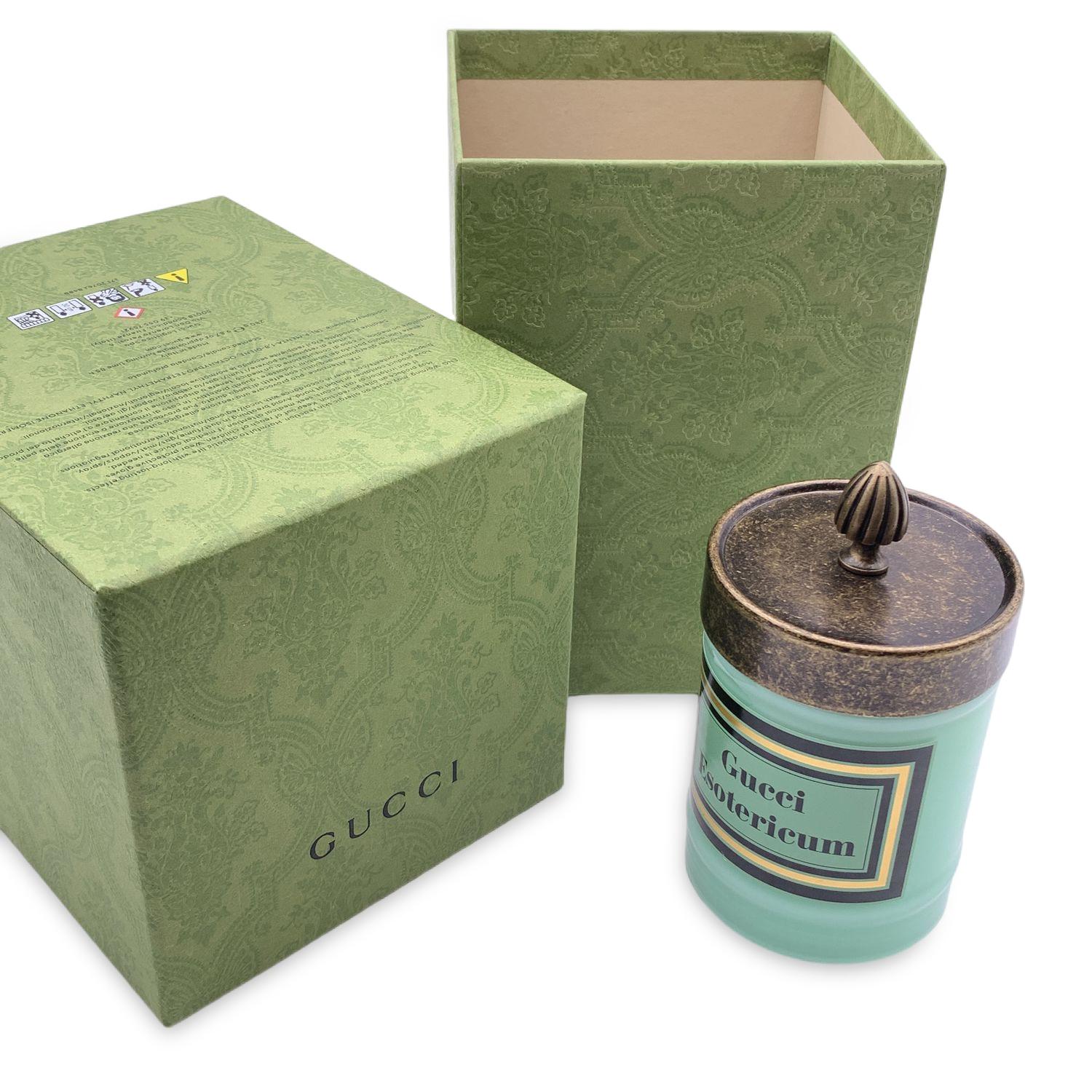 Beautiful Gucci 'Esotericum' Scented candle. Wax is scented with a blend of jasmine, bitter orange and leather notes. It features a metal lid with an engraved knob, and aqua green glass jar (it may be repurposed once the candle has burned out).Made
