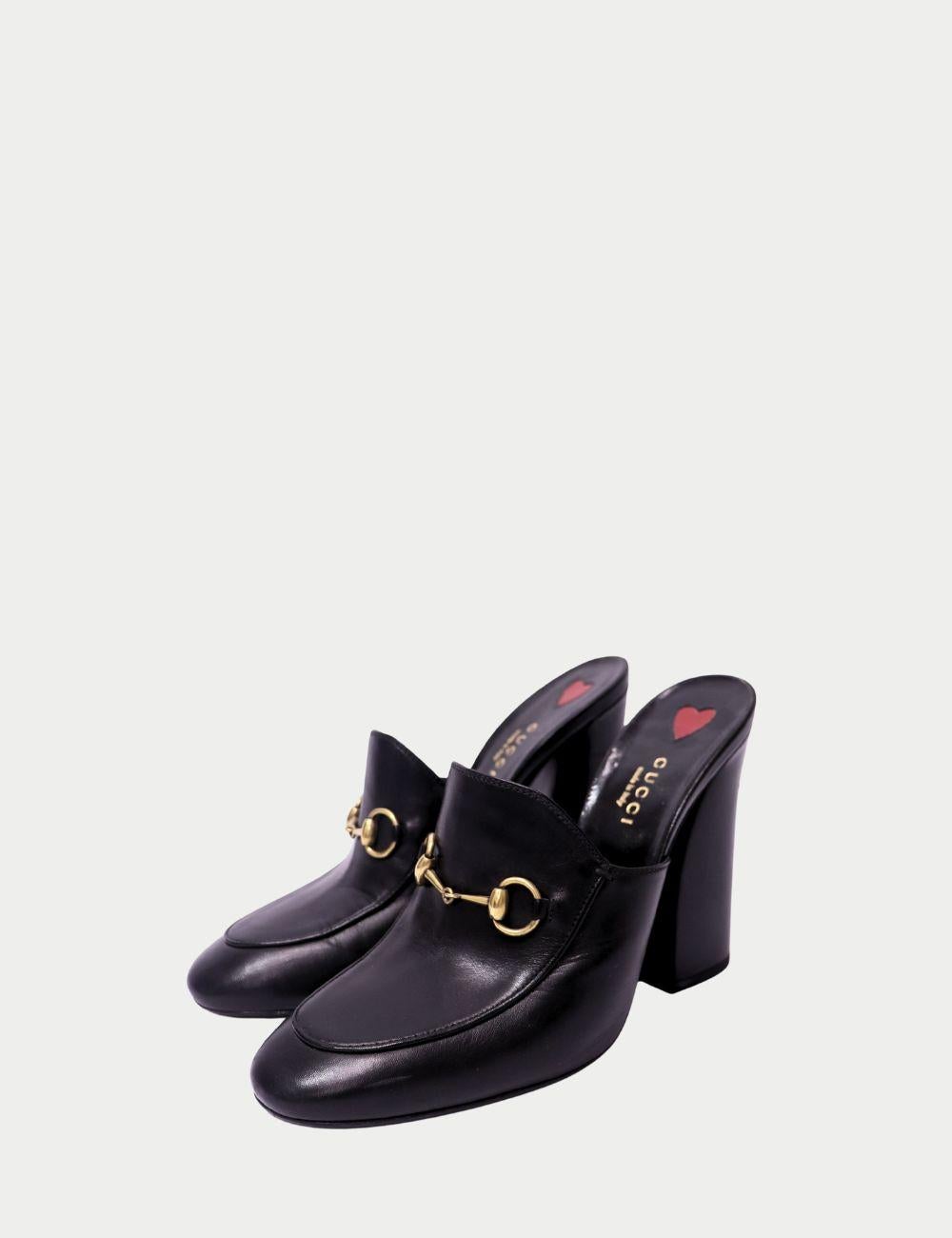 Mules Gucci Horsebit de piel negra

Adéntrate en la elegancia italiana atemporal con estas auténticas mules horsebit de piel negra de Gucci. Fabricado por expertos en Italia, este diseño presenta el icónico detalle del bocado dorado de Gucci en la