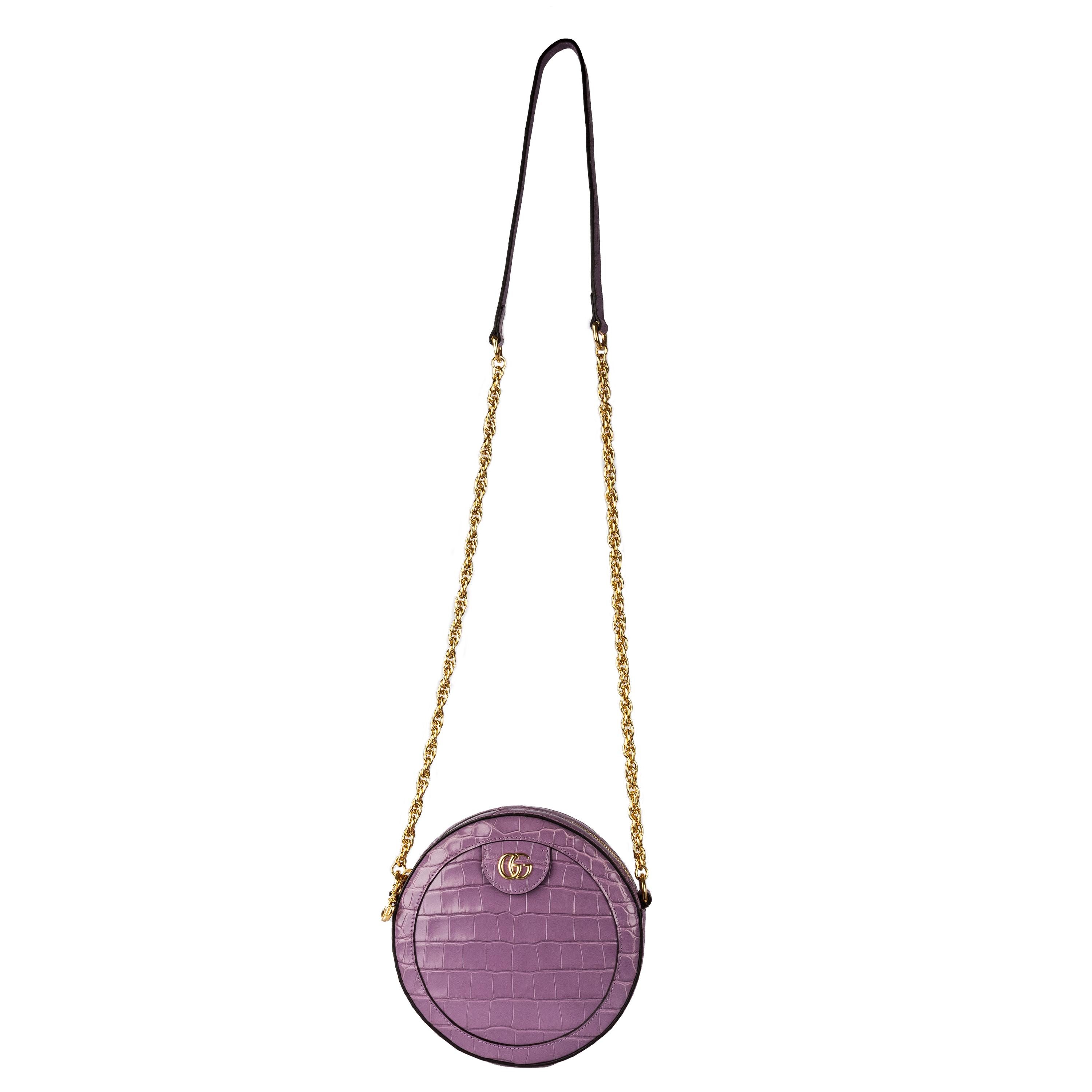 The Ophidia range welcomes a round mini bag in opulent crocodile leather, presented in an elegant lilac color. Crafted from luxurious crocodile leather, this Gucci Ophidia crossbody bag will elevate any outfit. It features a comfortable chain