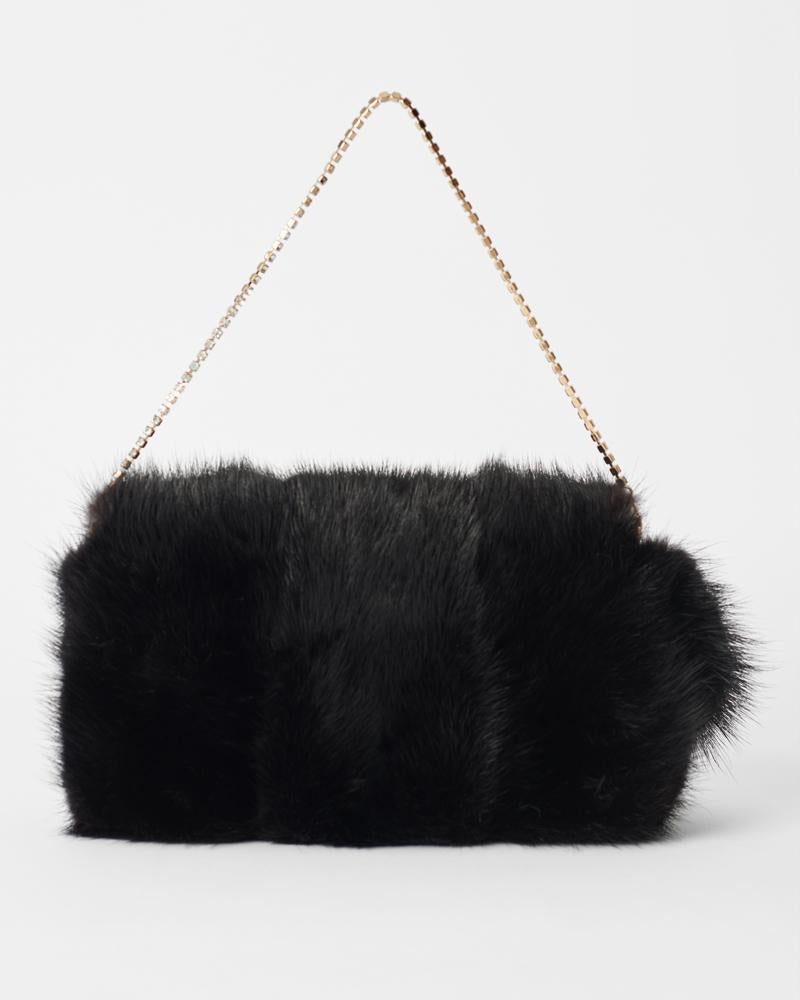 We are excited to present this iconic Gucci by Tom Ford Fall Winter 2004 mink fur bag, as seen on the runway. Features mink fur body, detachable crystal chain, embellished gold dragon with pearl centre on front and magnetic closure. In excellent