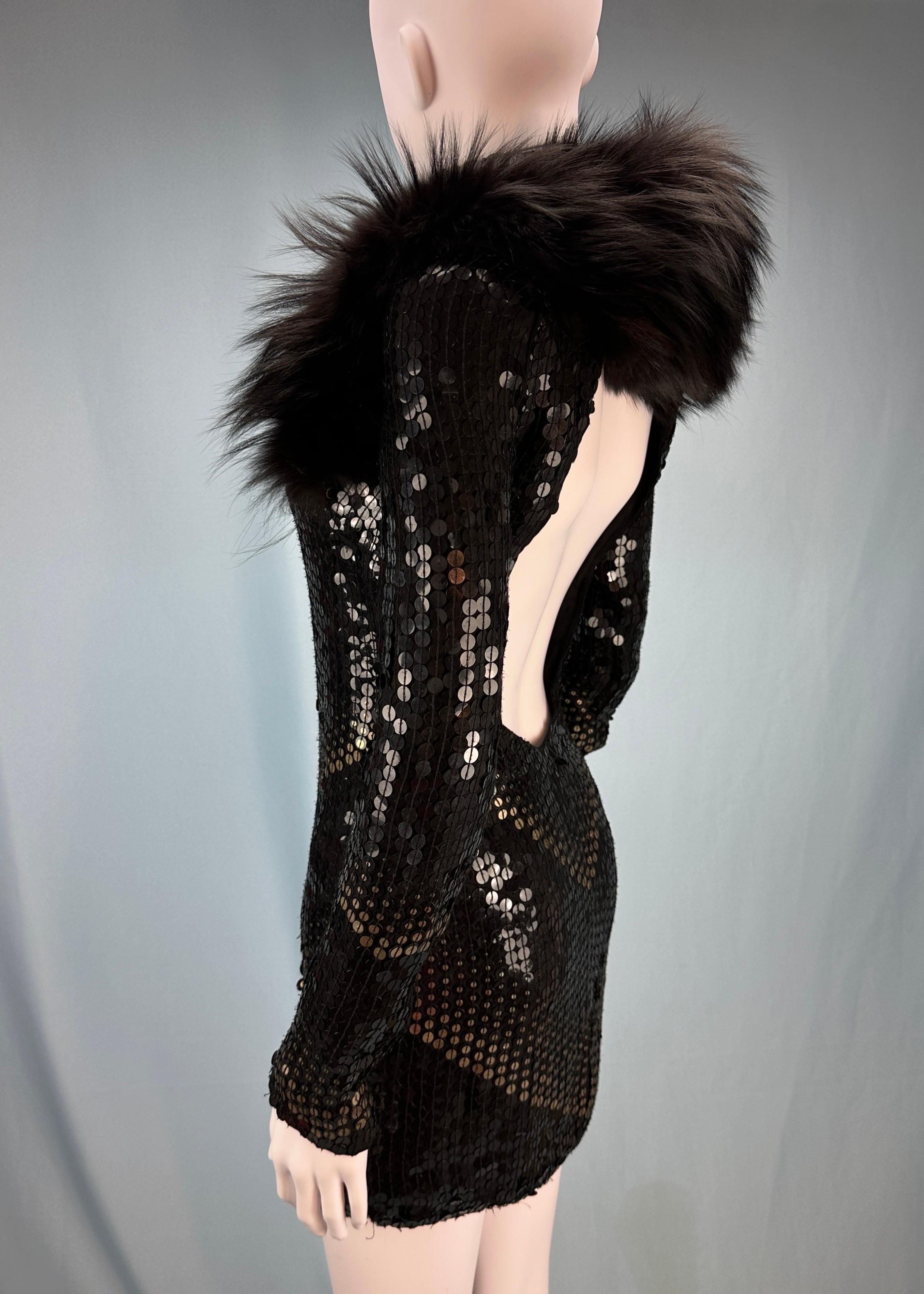 Gucci
by Frida Giannini
Fall 2006 - seen on the runway & in an editorial on Kate Moss 

Black and gold sequin mini dress with fox fur detail
Open back
Removable fox fur scarf, can be worn over the shoulders or neck
Zips on sleeve cuffs 
Zip up