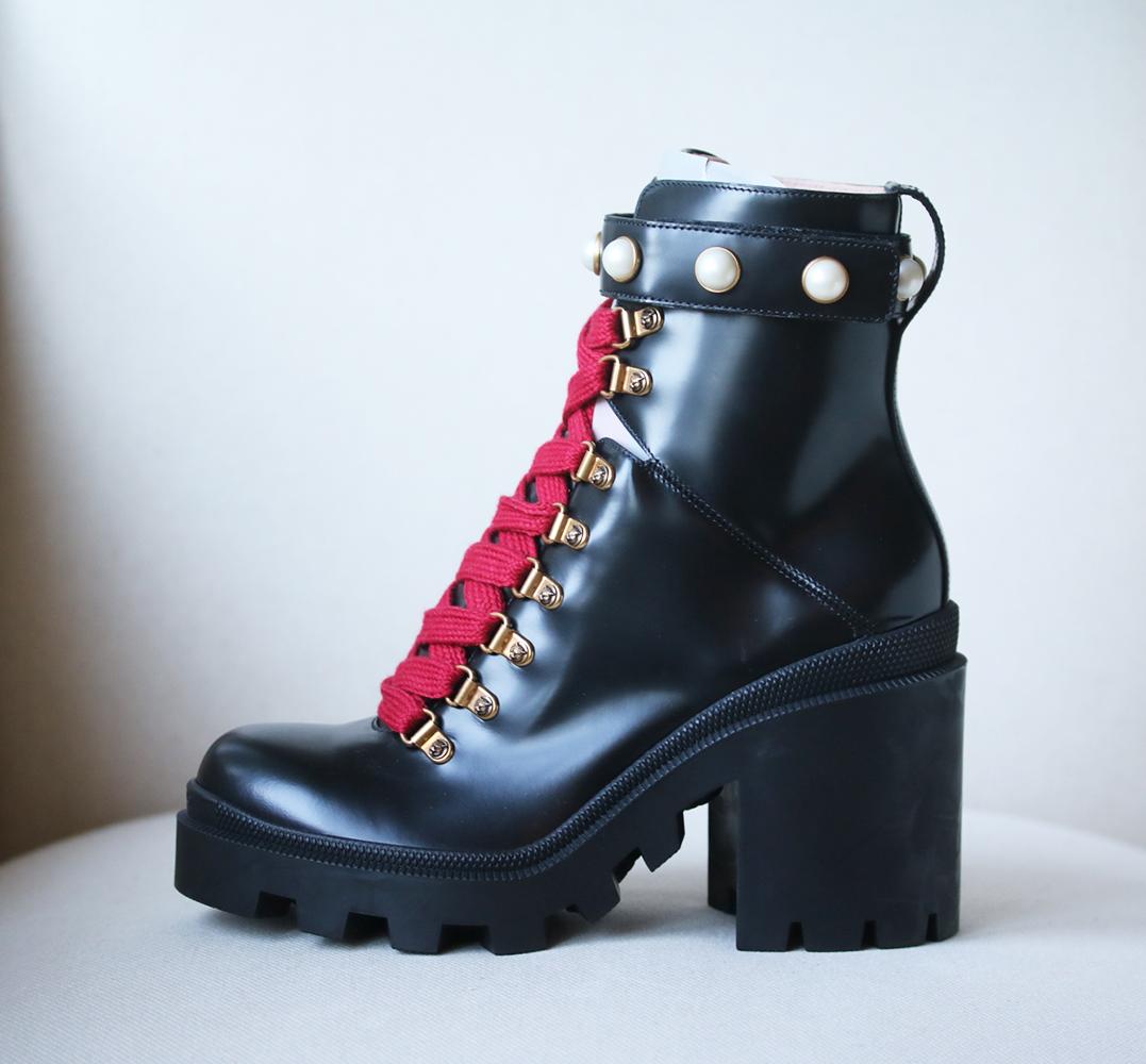 Made in Italy from smooth black leather, they're punctuated with glossy faux pearls and have contrasting magenta laces. Heel measures approximately 70mm/ 3 inches. Black leather (Lamb). Lace-up front, Velcro®-fastening ankle strap. Made in Italy.