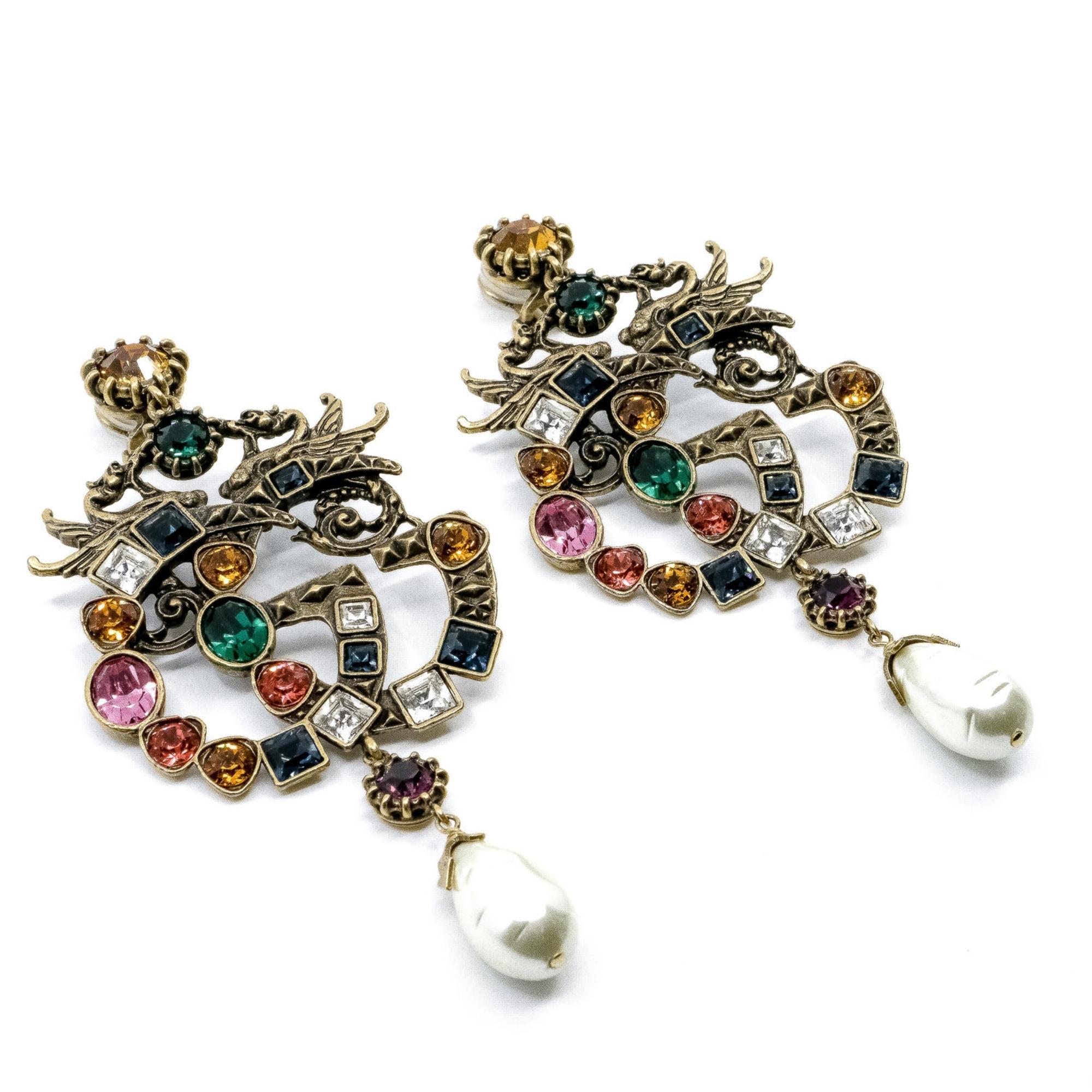 These classic GG Gucci earrings are made in an aged gold tone metal and embellished with large pearls snd the GG logo encrusted in multicolored crystals.

Color: Gold tone and multicolour strass
Material: Gold-Tone Metal, Faux Pearl,