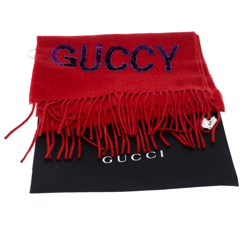 Beautifully cut from silk and cashmere, this Gucci scarf features a sequin GUCCY logo on the bright red background. It is finished with fringed edges. Make this gorgeous scarf yours today, and flaunt it like a fashionista!

Includes: The Luxury