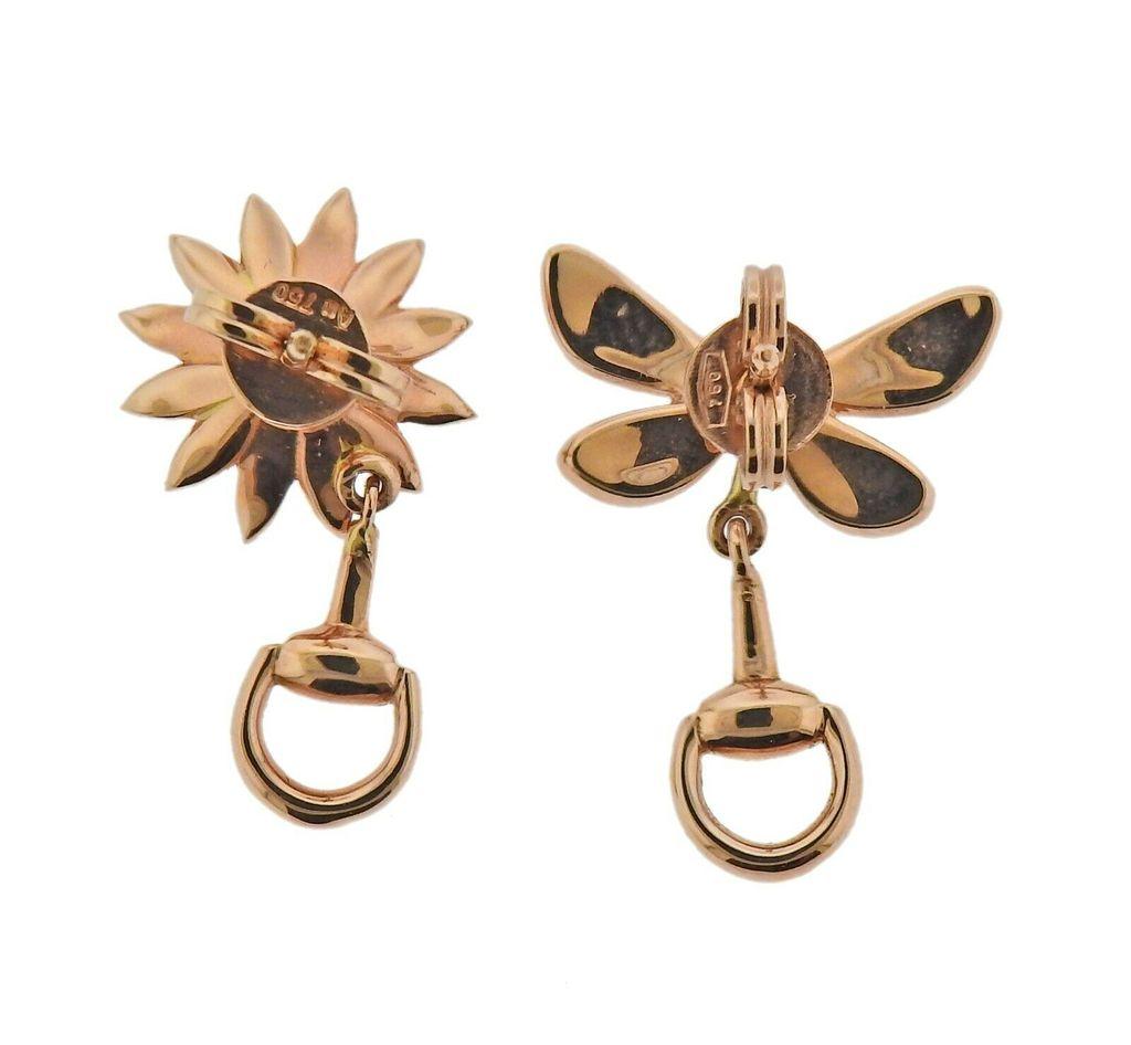 Pair of new 18k rose gold earrings by Gucci, with ruby, depicting a butterfly and a flower, with enamel. Flower - 23mm x 12mm, Butterfly - 22mm x 15mm Weight - 3.6 grams. Marked: Gucci, 750.
