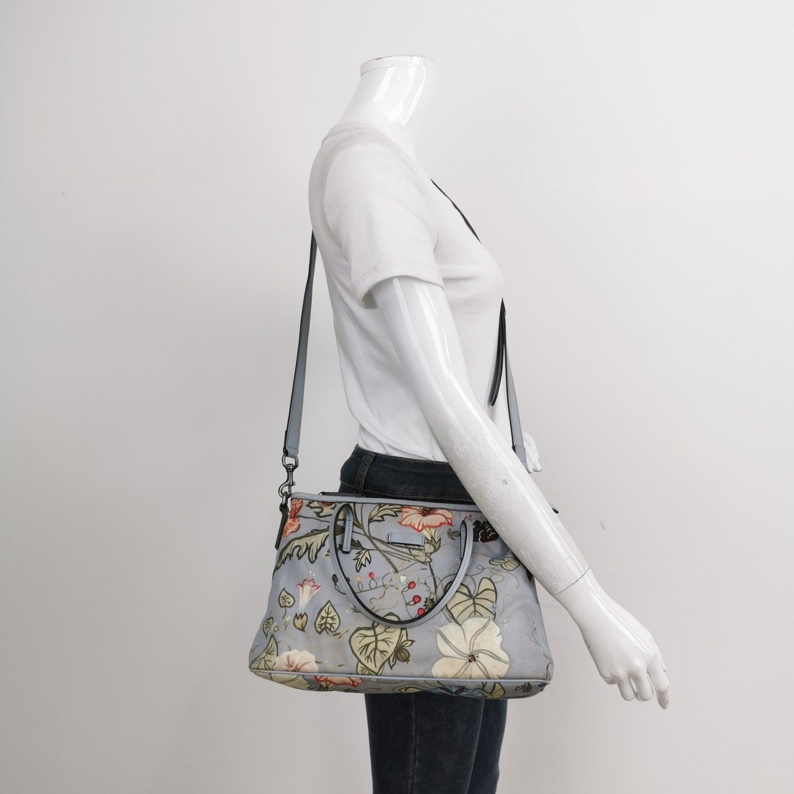 Gucci Flora Knight Tote Blue Nylon and Leather Small These are professional photos of the actual bag offered by Luxbags. Brand: GucciModel: Knight ToteExterior Material: Nylon and leatherExterior Color: BlueHardware Color: SilverDimensions: Width: