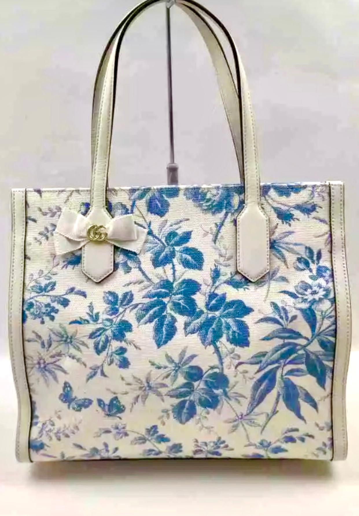 Flora medium leather-trimmed printed canvas tote
Latest and Hot 
 Gucci Flora medium sized handbag. With an off white canvas with a bright colorful floral pattern. The tote features White  leather at the base, trim, and top handles . The top