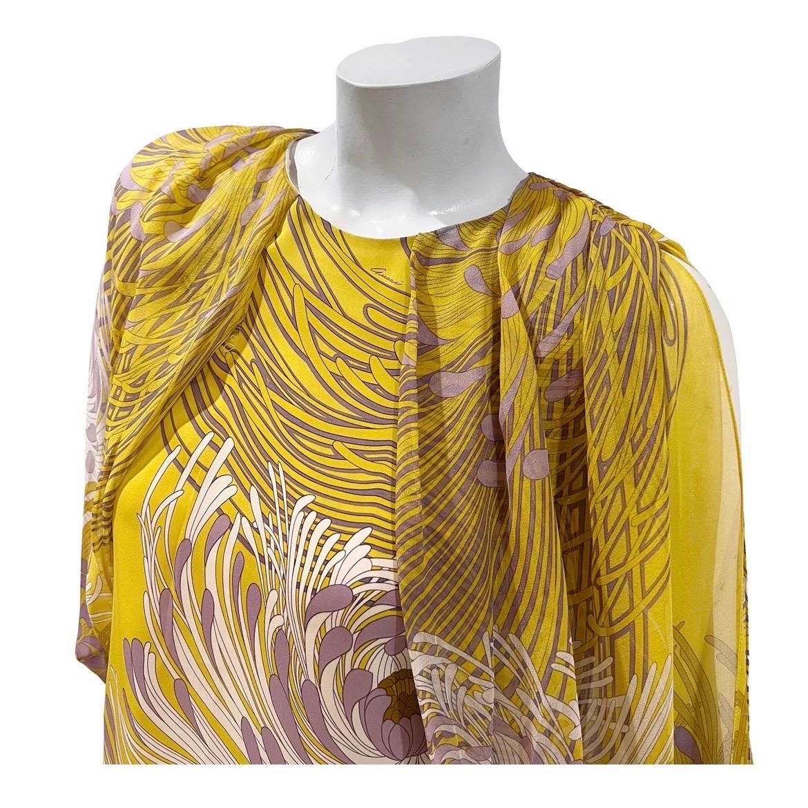 Floral chiffon blouse by Frida Giannini for Gucci 
Circa 2012 
Made in Italy
Chartreuse with violet and white floral motif throughout
Lined tank top shell
Open batwing semi-sheer sleeve with multi-button cuff closure
Slitted back with single button