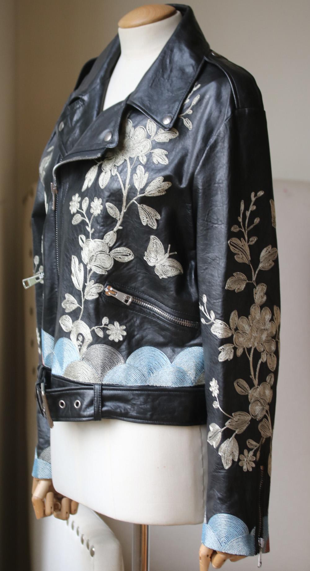 Gucci's leather biker jacket has been hand-embroidered with flowers and butterflies. Framed with metallic silver, dusky-blue and pink thread embroidery. This slim-fit design is lined in silk. Black leather. Asymmetric zip fastening through front.