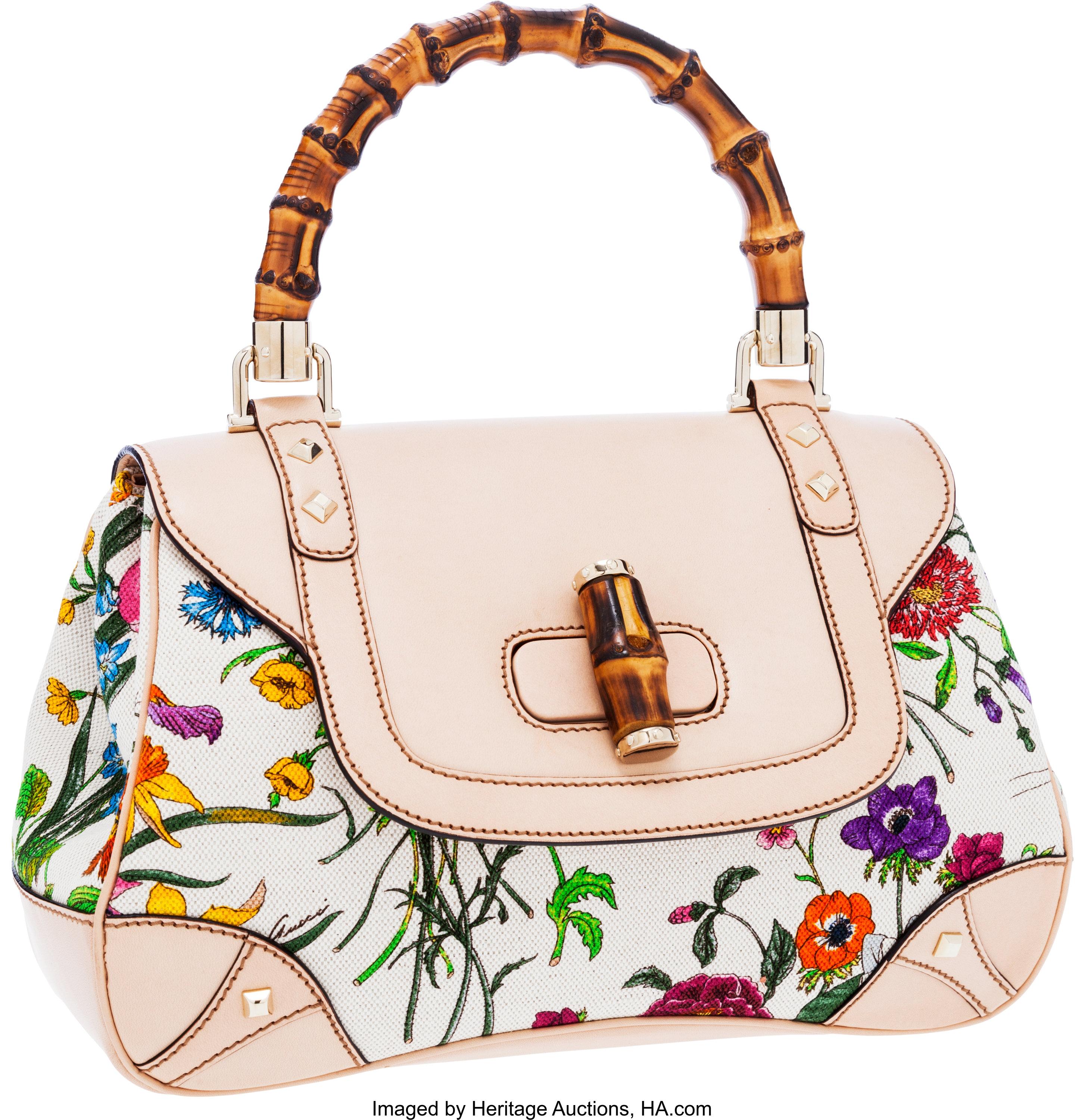 GUCCI Floral Flora Canvas Bag in bright multi-color flora print canvas and leather featuring bamboo top handle, half frontal flap with a bamboo turn lock, brass hardware & partitioned fabric interior with 1 zip closure pocket. 100% Authentic. No