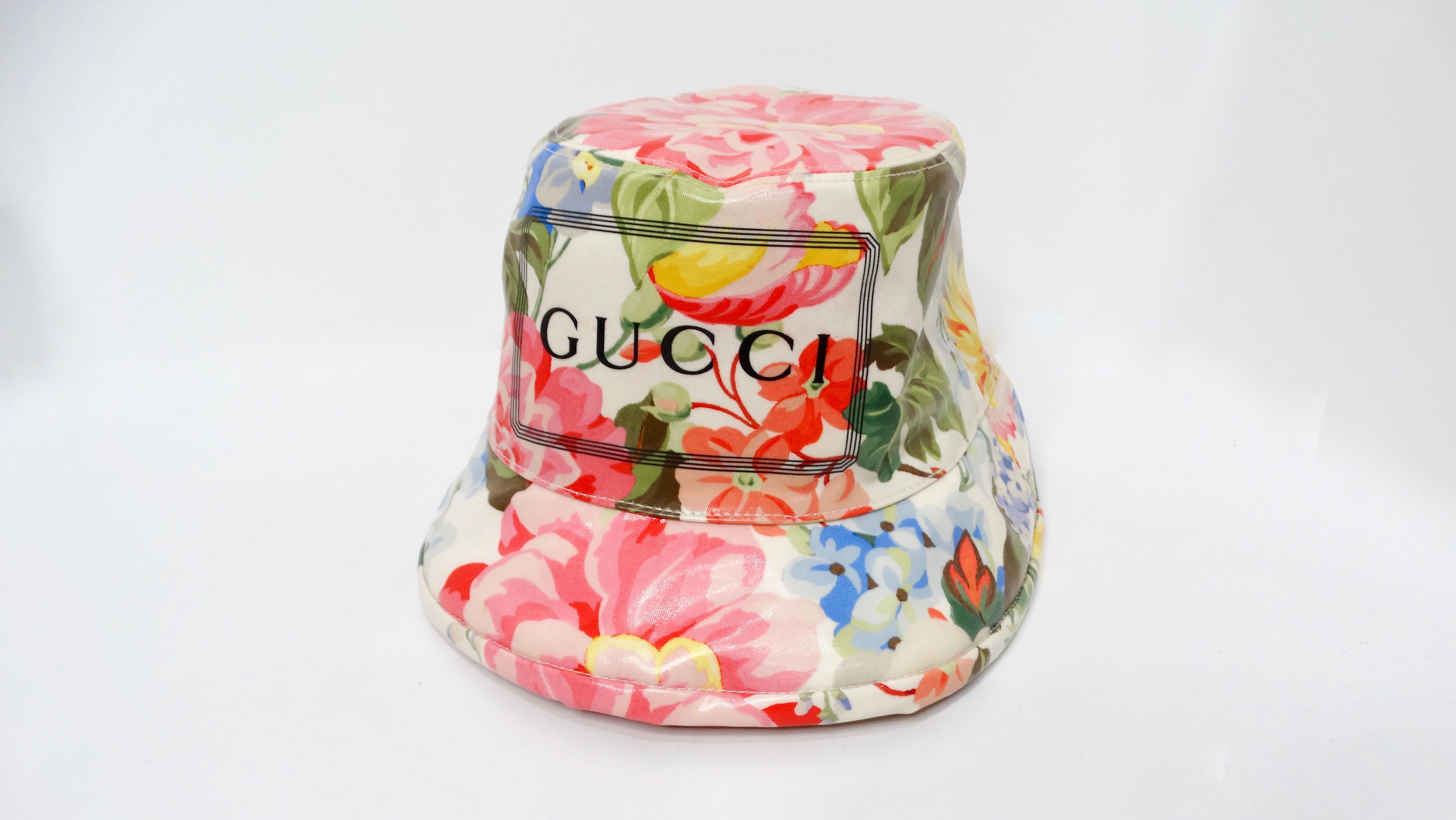 The Gucci Floral Print Shiny Coated Cotton Bucket Hat epitomizes fashion-forward functionality, merging playful elegance with practical design. Crafted from high-quality coated cotton, this hat showcases a vibrant floral pattern that bursts with