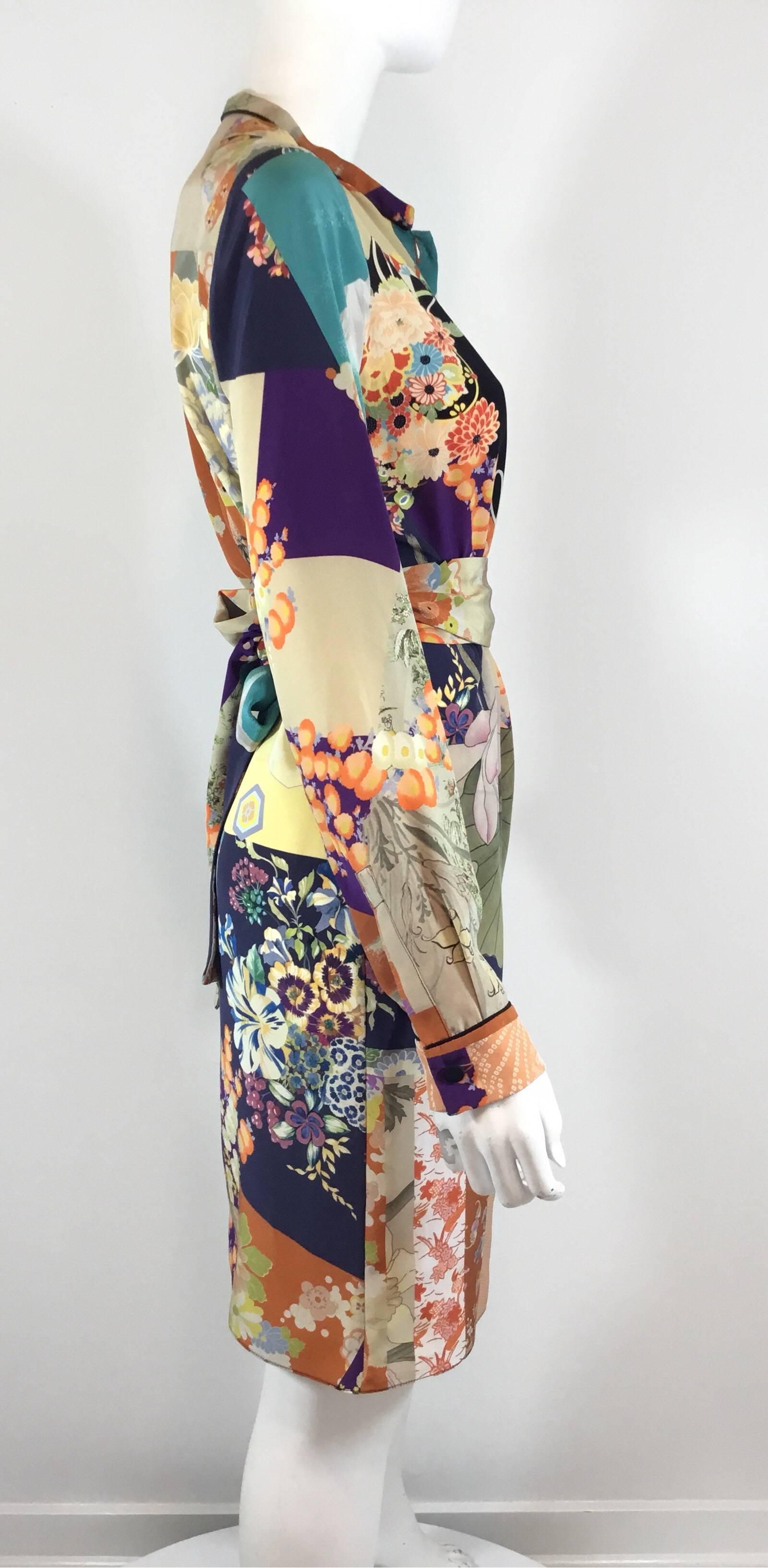 Gucci silk print dress features a multicolored Japaneses inspired floral print throughout with an optional waist tie fastening, and button closures at the neck and cuffs. 100% silk, labeled size 42, made in Italy. Excellent condition.

Measurements: