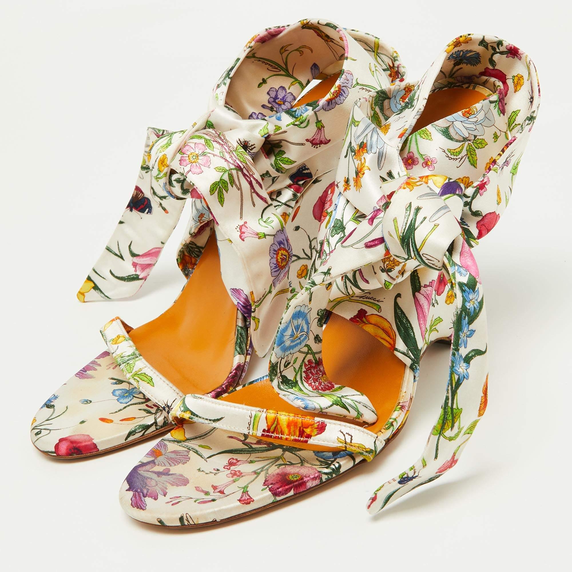 Gucci's sandals are a perfect pair to style your cute summer dresses with. Designed in a floral print satin with an ankle strap tie-around closure, they have wedge heels to wear all day long.

