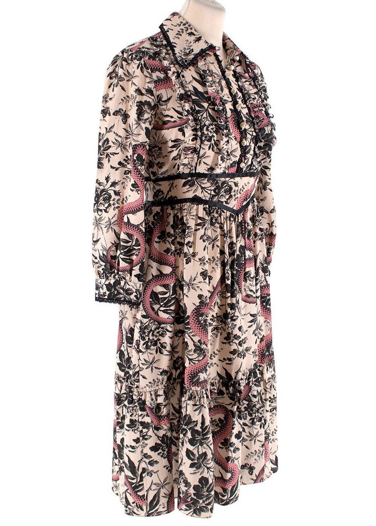 Gucci Floral Snake Print Ruffle Midi Dress

- Lightweight silk
- Collar with black lace ruffle
- Pearl button and loop front fastening
- Belt
- Ruffle detailing
- Long sleeves
- Concealed zip fastening at