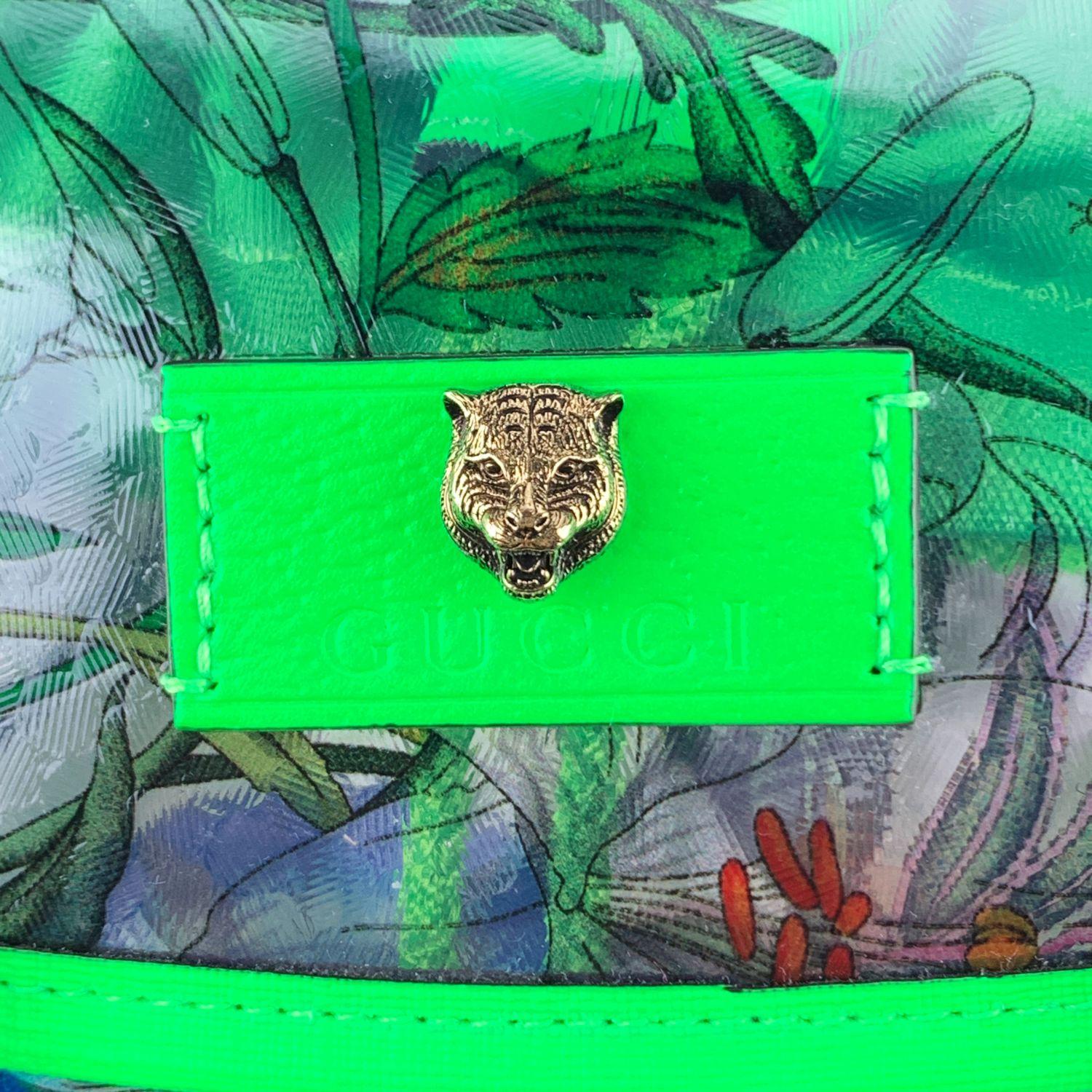 Beautiful large unisex 'Flora' backpack by Gucci. The backpack is crafted in clear PVC with Flora print with fluo green leather trim. The bag features a flap top with double buckle closure, drawstring fastening under the flap, 1 zip pocket on top