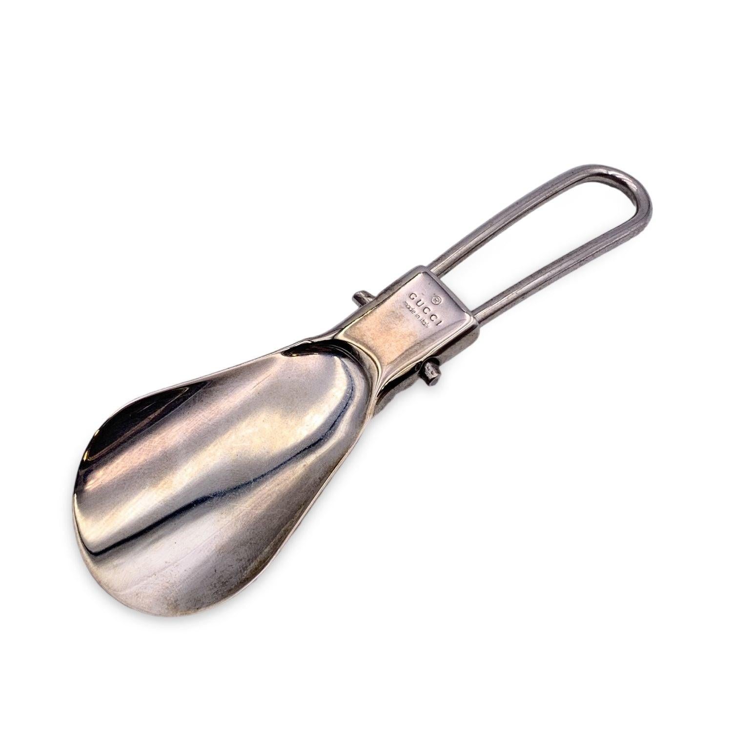 Foldable silver metal mini shoe horn by GUCCI with white Guccissima leather case. 'GUCCI Made in Italy' engraved on the shoehorn. Total lenght: 4.5 inches - 11.4 cm Condition B - VERY GOOD Gently used. Some normal wear of use on leather case. Some
