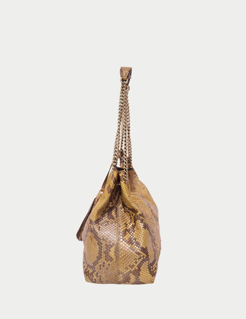 Gucci Python Embossed Leather Chain Shoulder Bag – Tassel Detail


Make a bold fashion statement with the Gucci Python Embossed Leather Chain Shoulder Bag, a striking blend of luxury and exotic style. Crafted from premium leather with a golden-brown