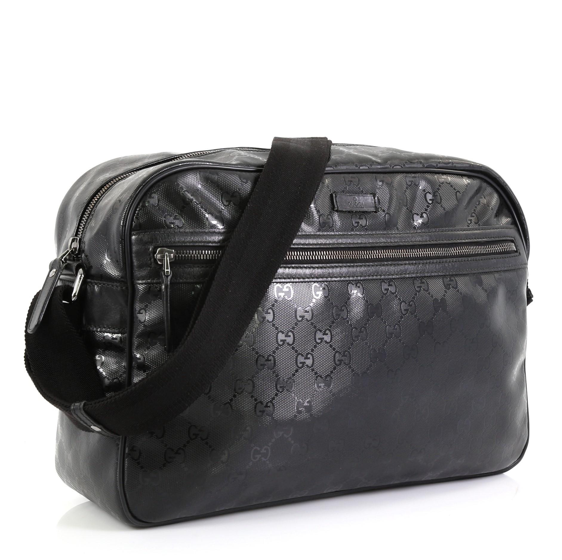 This Gucci Front Zip Camera Bag GG Coated Canvas Large, crafted in black GG coated canvas, features adjustable canvas strap, black leather trims, exterior front zip pocket and silver-tone hardware. Its zip closure opens to a black fabric interior