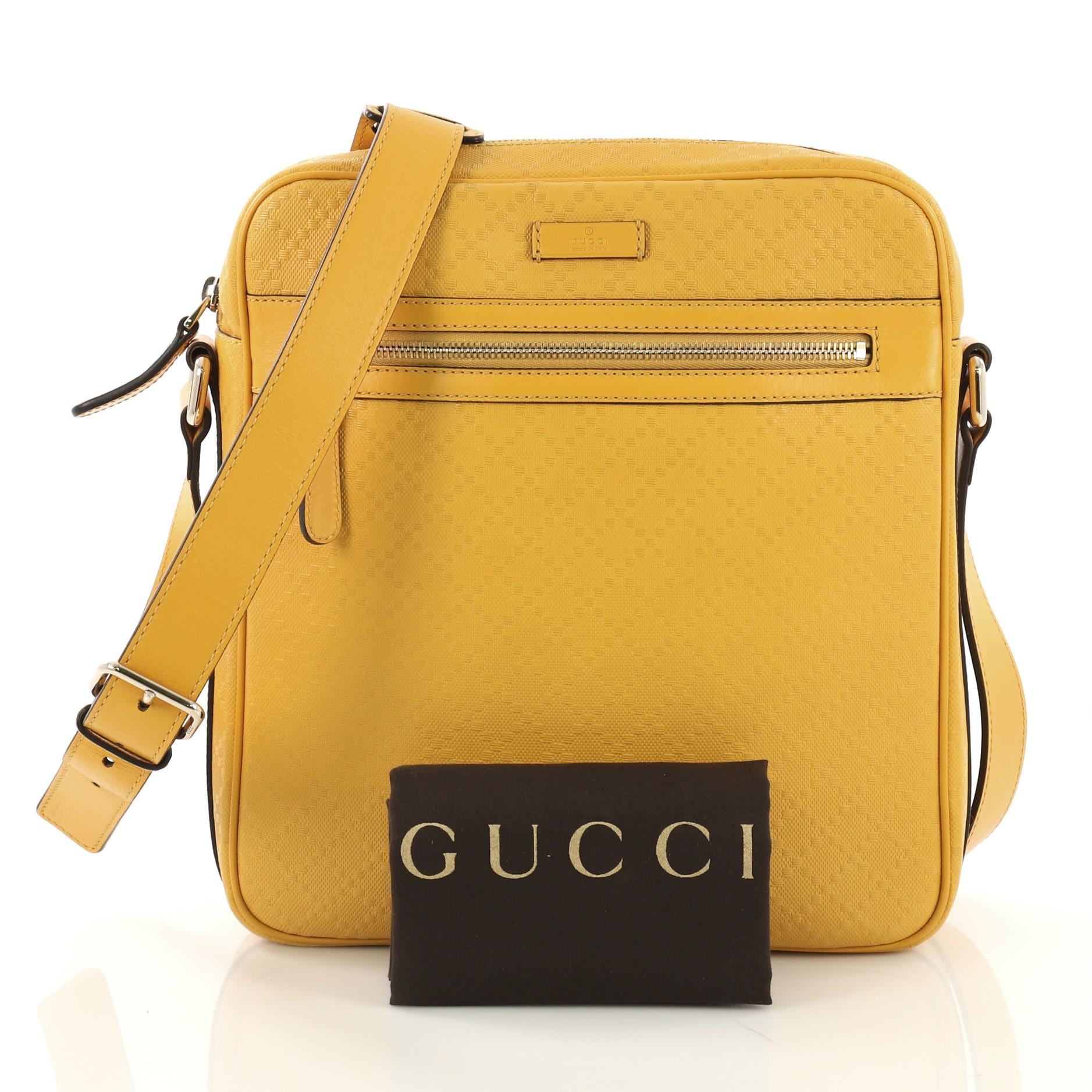 This Gucci Front Zip Messenger Diamante Leather Medium, crafted in yellow diamante Leather, features an adjustable leather strap, leather trim, front zip pocket, and gold-tone hardware. Its top zip closure opens to a brown fabric interior with side
