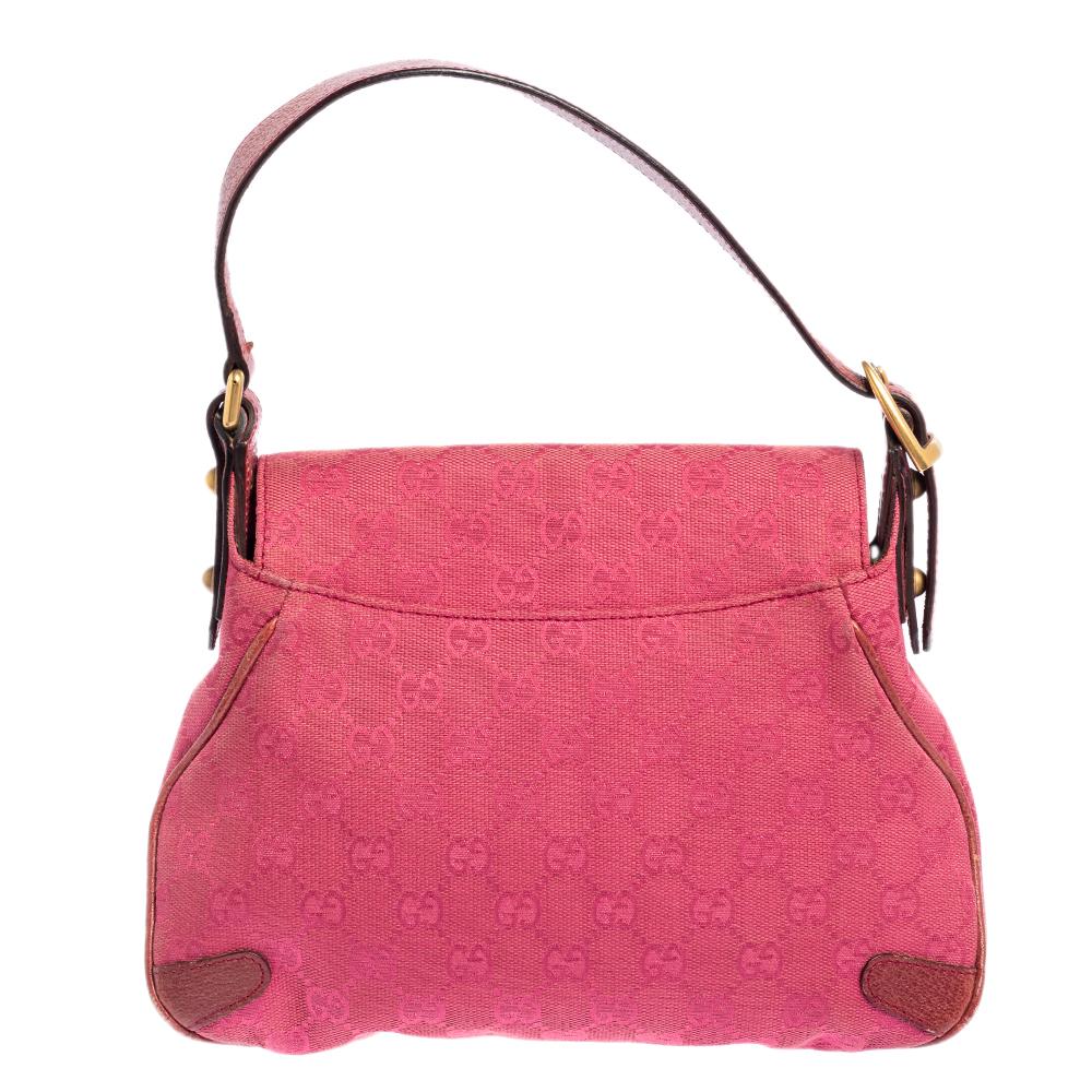 Complete a stylish look with this beautiful Gucci satchel. It is made from pink GG canvas and leather and has the iconic Horsebit accent at the front. The front flap opens to a fabric-lined interior that houses a zip pocket. This satchel is complete