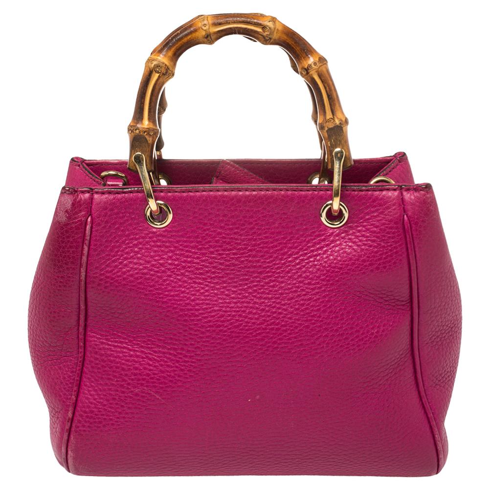 Handbags as fabulous as this one are hard to come by. So, own this gorgeous Gucci tote today and light up your closet! Crafted from fuchsia leather, this stunning number has a spacious canvas interior and is wonderfully held by a shoulder strap and