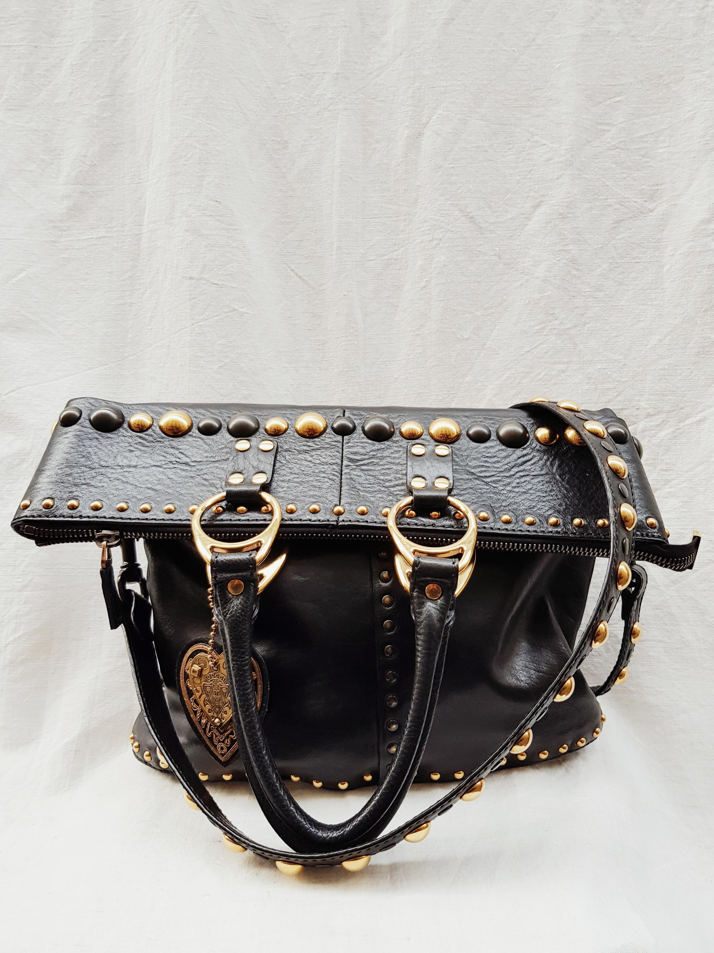 Everything can fit into this beautiful bag, great as a tote, and it’s long. Or as a crossbody and it’s folded over.

-Comes with a detachable and black studded leather strap
-Gucci Babouska studs in gold and bronze
-Bronze tone Gucci engraved