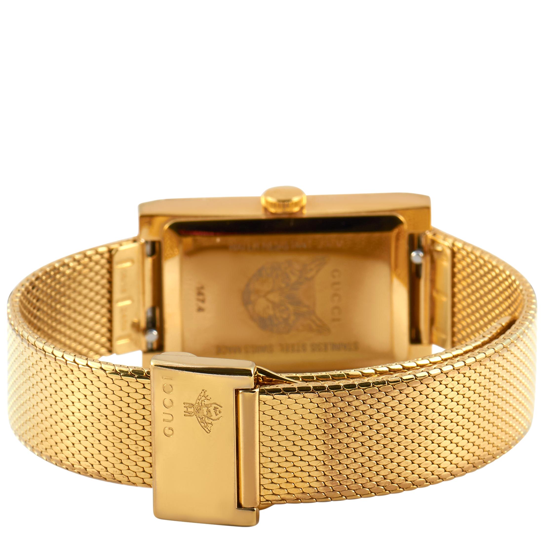 The Gucci G-Frame watch, reference number YA147410, is presented with a yellow gold-tone stainless steel case that is water-resistant to 30 meters. The case is mounted onto a matching yellow gold-tone stainless steel mesh bracelet, secured on the