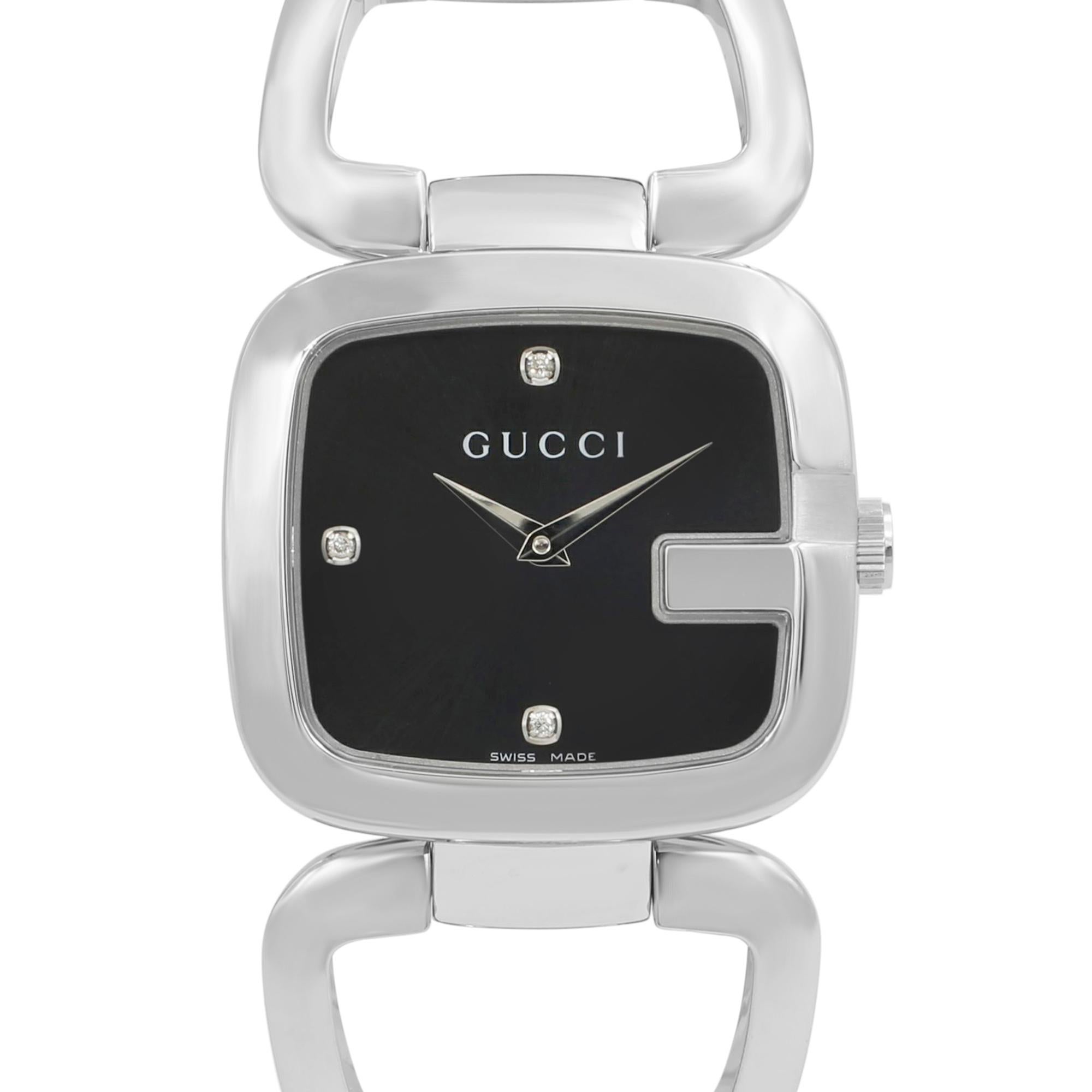 This display model Gucci G-Gucci YA125406 is a beautiful Ladies timepiece that is powered by a quartz movement which is cased in a stainless steel case. It has a rectangle shape face, diamonds dial and has hand diamonds style markers. It is